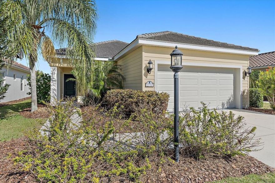 One or more photo(s) has been virtually staged. BETTER THAN NEW AND WAITING FOR YOU! Enjoy this charming MAINTENANCE-FREE home on a premium lakefront lot, only 3 doors down from the "Restort-style" AMENITY CENTER in the #1 MASTER PLANNED Community in the USA! *NO CDD *LOW HOA *WHOLE-HOUSE GENERATOR *WHOLE-HOUSEWATER SOFTENER *WATER VIEWS and ready for IMMEDIATE OCCUPANCY! IMMACULATE 3bed/2bath with OFFICE and EXTENDED WATERFRONT LANAI. This fantastic layout will complement any lifestyle! Off the great room, elegant French doors lead into the WOOD FLOOR office. An inviting kitchen with elevated features like *WOOD CABINETS *GRANITE COUNTERTOPS *GAS STOVE and *SLIDING DOORS (provide countless entertainment options). Stay safe with ROLL-DOWN HURRICANE SHUTTERS on the lanai. The Master bedroom enjoys direct entry into the lanai with a WALK-IN CLOSET and a spacious bathroom. Relish in the benefits of a GAS HOME and INCLUDED LAWN MAINTENANCE using RECLAIMED WATER, which will save on your water bill. Indigo's amenities include a heated pool and spa, a 24/7 fitness center with yoga room, pickleball courts, bocce ball courts, and a full-time lifestyle director. Lakewood Ranch has something for everyone with over ~150 miles of walking/bike trails, parks, playgrounds, over 85 restaurants within 20 minutes, shopping, dining, "A+ rated" schools, and world-famous beaches. Start living the Florida life now!