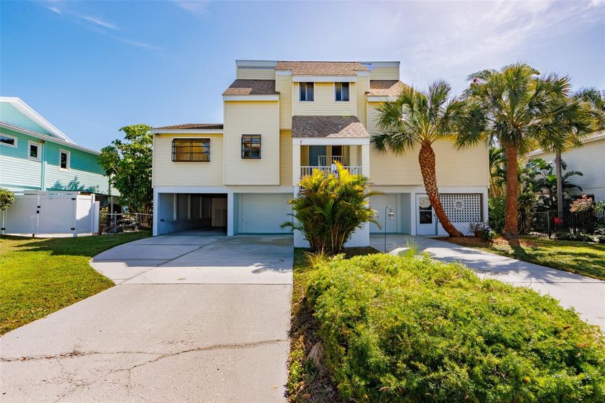 This charming elevated Anna Maria Island home is on a wide canal and is located on the north end of the island.  This four bedroom, three and a half bath house is spacious and perfect for boaters!  Enjoy the open concept living area and 2 sets of sliding glass doors to step right out onto your large balcony. Enjoy the beautiful view and watch the dolphins and manatees frolic in the water.   This home is welcoming and has so much potential, with just a little TLC make it your own with special touches.  The rooms are all very specious and have colorful fun wallpaper in each bathroom.   Enjoy the large backyard, plenty of room for a pool to add.  Fish off the dock or hop on your boat for a sunset cruise, there are no bridges going out to Tampa Bay.  Plenty of room for parking with a 1 car attached garage, 1 spot carport, workshop and 2 huge driveways.  Come take a look today, you don’t want to miss this!