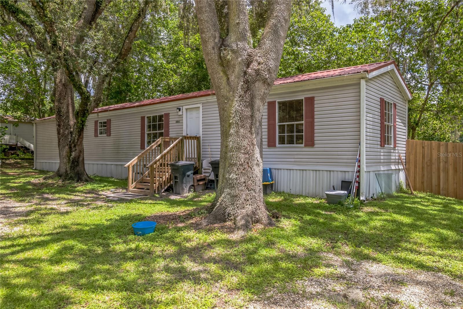 Manufactured Home Completely Updated in 2024. This SE 2/2 Home is set on a Large .31 shady acre lot. The Kitchen features All New (2024) Stainless-Steel Appliances, Refrigerator, Range, Above the Range Microwave and Dishwasher! There are also Beautiful New (2024) cabinets for plenty of storage and New (2024) Beautiful Granite Countertops. The Kitchen looks out onto the Large Living Room/Dining Room combo area. The Split Plan bedrooms both feature their own completely updated bathrooms with all New (2024) fixtures, vanities and granite countertops! The Indoor Laundry has a new (2024) Whirlpool washer and dryer and shelving for storage. New (2024) Water Heater and HVAC system also installed. This updated home will provide years of worry-free living!