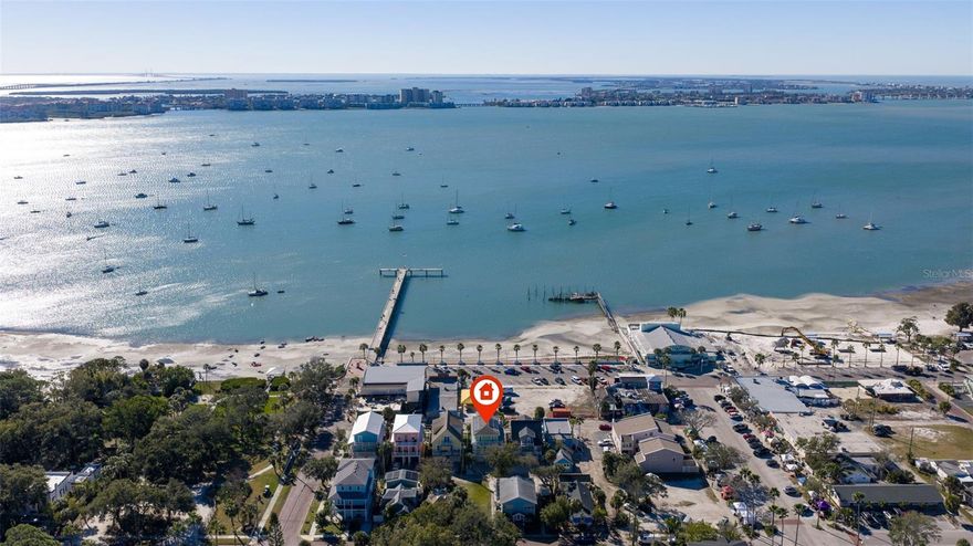 Waterfront-Turnkey-Short-Term Rental investment opportunity in the heart of Gulfport’s Historic Art District! This fully furnished, Key West-inspired coastal retreat offers short-term vacation rental potential, breathtaking Boca Ciega Bay views, and an unbeatable walkable location just steps from downtown Gulfport’s restaurants, galleries, waterfront parks, nightlife, and popular Tuesday Farmers Market. Whether you’re seeking a high-performing Airbnb/VRBO property, second home, or full-time waterfront residence, this exceptional home delivers the perfect combination of lifestyle and income-producing potential. Guests and owners alike will love the private outdoor living spaces with panoramic water views overlooking Veteran’s Park—ideal for morning coffee, sunset cocktails, and entertaining in true Florida style. Inside, coastal elegance meets modern luxury with an open-concept layout designed for comfort and hosting. The gourmet kitchen features stone countertops, extensive cabinetry, abundant storage, and premium finishes perfect for entertaining vacation guests or everyday living. The luxurious primary suite serves as a private sanctuary with a professionally designed walk-in closet system and a spa-inspired ensuite bath complete with a whirlpool tub, dual vanities, and oversized enclosed shower. The third floor features private outdoor decks off the primary, second, and third bedrooms, offering incredible sunset views and refreshing coastal breezes that make Gulfport one of Tampa Bay’s most beloved waterfront communities. Built for durability, efficiency, and low-maintenance ownership, the home includes an elevator, impact-rated windows, Hardie plank siding, Trex decking, turf landscaping, and a whole-home solar system for significantly reduced electric costs. The oversized two-car garage provides ample room for vehicles, kayaks, jet skis, beach gear, or additional owner storage. Located just minutes from Downtown St. Petersburg, award-winning Gulf beaches, marinas, and Tampa Bay attractions, this rare turnkey short-term rental property is ready to generate income immediately while offering an incredible waterfront lifestyle. Opportunities like this in Gulfport’s Historic Waterfront District are exceptionally rare.