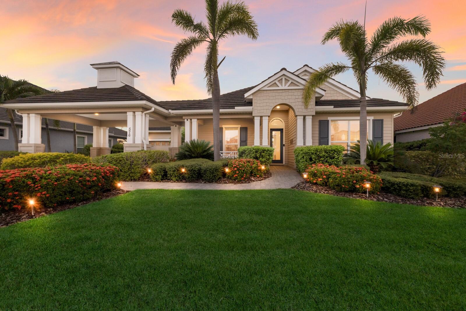 Custom-built coastal elegance meets effortless waterfront living in the coveted gated community, Harbour Walk. Nestled on a wide, deep-water canal with Lock-Free access to Manatee River, this residence offers the best of Florida boating from your private dock - just minutes to sugar-sand beaches, dock-and-dine restaurants & marinas, as well as the Intracoastal, Tampa Bay & the Gulf. Lush curb appeal sets the tone with classic coastal HardiePlank siding, a paver driveway, and graceful portico parking. Inside, refined craftsmanship shines - 13-foot tray ceilings with crown molding, 8-foot doors, and 22-inch tile laid on the diagonal create an airy, upscale ambiance. Thoughtfully planned, the home offers 3 bedrooms plus an office and 3 bathrooms, including a convenient pool-access bath. Plantation shutters in all bedrooms add clean lines & timeless style. The open-concept heart of the home is made for entertaining: an expansive 10-foot island anchors a chef’s kitchen with granite countertops, gas cooktop, built-in oven, and a walk-in pantry with custom built-ins - all finished with elegant espresso, soft-close cabinetry. Your primary suite is a private retreat with serene views of the pool, canal, and nightly sunsets. The spa-style ensuite features a large shower, separate vanities, a custom walk-in closet, and a chic sitting area with mirrors. Step outside to your personal resort: a heated saltwater pool and spa surrounded by an expansive paver deck for sun-soaked days and golden-hour dinners. On the water, a composite dock stands ready for adventure with a 16,000-lb boat lift, tandem jetski lift, fish-cleaning station, and a floating kayak dock. This is Florida living—elevated. A coastal sanctuary where style, comfort, and the call of the water come together seamlessly. Come fall in love with the home and the lifestyle it offers.