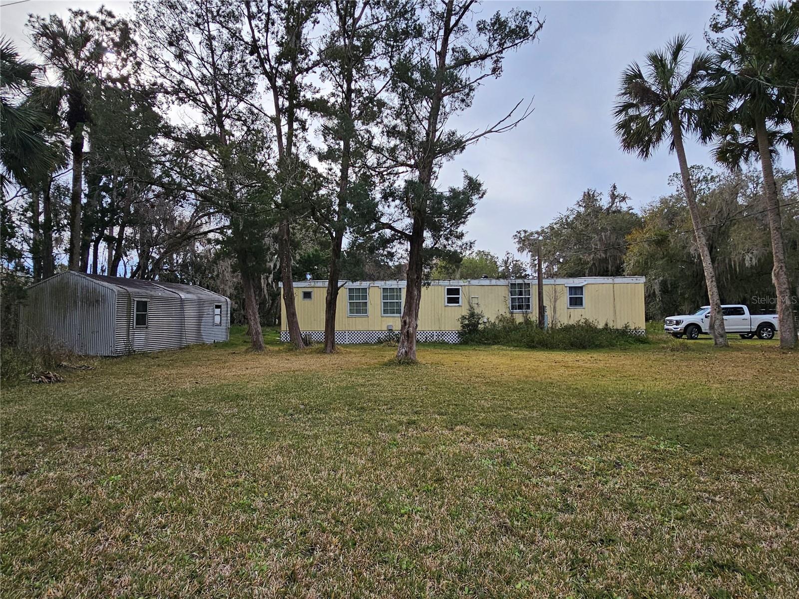 OWNER MOTIVATED FOR QUICK SALE! This older manufactured home is sold "AS IS". It is located .3 miles to Bull Creek Fish Camp and 14 miles to Bunnell. Bull Creek is a county owned park and recreational facility that is undergoing a total renovation and are adding a restaurant and additional camp sites. There is a boat ramp that leads you to some of the country's best bass and spec fishing on Crescent Lake. This little home with a little love will make a great investment property for rental or an affordable home for someone with limited income. Bring your imagination and a some handyman skills. Or remove the current home and replace with a new one (save on impact fees) Owner has priced it to sell.
Condition of well and septic are unknown. It is currently working and power is hooked up.
THIS HOME IS NOT AVAILABLE FOR RENT! AND NO OWNER FINANCING!