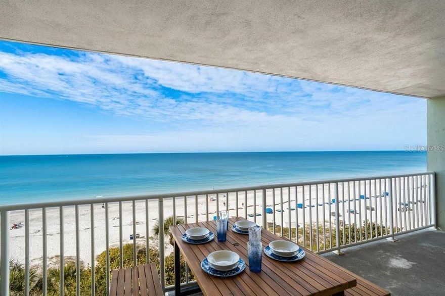 This furnished three-bedroom, two-bath condo sits Gulf-front in the Sand Castle in Indian Shores. From the master bedroom and the open kitchen, dining, and living room, you see the Gulf—dolphins moving through the light and sunsets that finish the day right. The second and third bedrooms look east to the Intracoastal, quiet and steady, with plantation shutters on the windows. The unit has been fully updated with quality finishes, featuring vinyl flooring throughout, made for beach days and bare feet. The kitchen is finished with quartz counters, a tile backsplash, and stainless appliances, opening cleanly into the living space. Both bathrooms are upgraded with tiled walk-in showers. Impact windows and sliders lead to a wide private balcony that runs the length of the unit, with hurricane shutters and a storage closet for chairs and gear. A washer and dryer are inside. Furnishings are newer and included. The building is well kept, with a new roof and updated elevators. Owners and guests have use of a heated pool, large spa, landscaped grounds, barbecue area, game room, library, and an owners-only clubhouse with kitchen, gathering space, and fitness equipment. Assigned parking sits under the building, with guest parking available. No pets. The beach is steps away, with a local pub across the street and Tampa International Airport and Busch Gardens an easy drive. Weekly rentals are allowed, offering strong income potential.