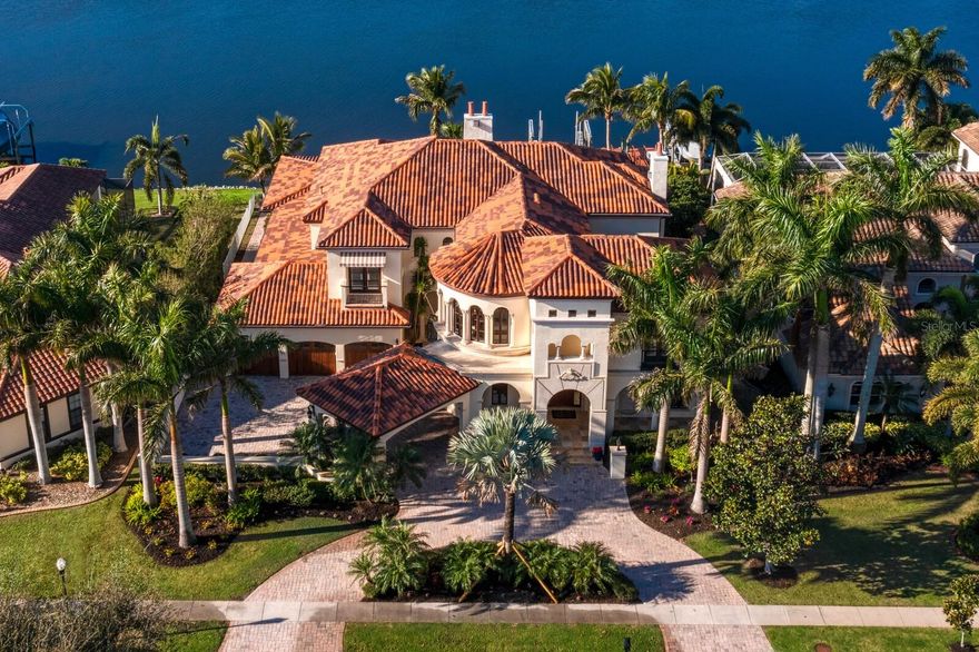 Welcome to Miramar, the spectacular Alvarez Homes-built waterfront estate and winner of the Tampa Bay Parade of Homes. Located in the exclusive waterfront community of MiraBay, discover the perfect blend of architectural genius, warmth and sophistication. Offering Mizner-inspired architecture and attention to detail from the porte-cochere entry, European motor court and classic courtyard, to the graceful winding staircase and colonnade gallery with groin-vaulted ceilings. Refined elegance and outstanding craftsmanship greet you with Brazilian hardwood floors, 24-foot ceilings, sweeping water views and stunning outdoor living areas. Offering water views throughout the light-filled living spaces, with endless windows and gracious entertaining areas, the thoughtful design was specifically crafted for glamorous gatherings and the best of waterfront lifestyles in this resort community. The first level features spacious areas to entertain with a grand two-story foyer entry, living room, adjacent drawing room with wet bar that opens to the courtyard, formal dining room and gathering room. The chef’s kitchen boasts top-of-the-line appliances (Wolf & Sub-Zero), Cohiba granite countertops, center island and breakfast bar, butler’s pantry, wine refrigeration and a cozy breakfast area. A second level owner’s retreat provides a welcomed respite with a vestibule entrance and opulent bath, walk-in closet, private waterfront terrace, fireplace and morning bar. Three additional guest bedrooms/baths and a study with water views also occupy the second level. Retracting glass doors lead to majestic outdoor living areas offering a veranda with fireplace, numerous entertaining areas, outdoor kitchen, infinity pool and spa overlooking the water. A private dock with lift assure you can spend endless days on the water, minutes from beaches and abundant outdoor recreation. Additional appointments include multiple terraces, dramatic arched doorways, venetian plaster walls, Old World craftsmanship and custom molding throughout, mud room, full entertaining wet bar and 3-car garage. Outstanding MiraBay amenities include 24-hour gated security, Clubhouse, heated resort-style Olympic swimming pool, water slide, parks, playgrounds, gym, cafe with a full liquor license, sports courts, fitness center, 135-acre lagoon with water activities and much more. Convenient to Tampa, Sarasota and St. Petersburg, TPA International and downtown Tampa, experience the very best Gulf beaches, shopping, dining, sports venues and entertainment. FURNISHINGS AVAILABLE AT ADDITIONAL COST.