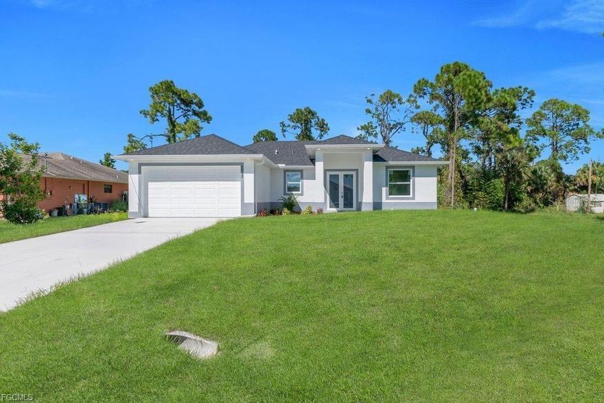 Welcome to an exceptional new construction residence in the heart of Lehigh Acres, where contemporary luxury meets thoughtful design. This impeccably crafted home presents an enticing blend of sophistication and practical living spaces, offering three bedrooms and two well-appointed bathrooms. Step through the elegant double-door entry into a home that exemplifies modern Florida living. The great room design creates an impressive sense of openness, seamlessly connecting living spaces and establishing an ideal environment for both entertaining and daily life. The heart of this home is its beautifully conceived kitchen, featuring a traditional eat-in design enhanced by a generous island that doubles as a casual dining space. Culinary enthusiasts will appreciate the complete suite of new stainless steel appliances, including a refrigerator, dishwasher, microwave, and range. The kitchen's sophisticated aesthetic is elevated by premium quartz countertops, which extend into the bathrooms, maintaining a cohesive design throughout. The primary bedroom suite stands as a private retreat, boasting a spacious walk-in closet and an elegant bathroom with dual sinks. Two additional bedrooms offer comfortable accommodations for family members or guests, while the second full bathroom ensures convenience for all. Throughout the residence, premium porcelain tile flooring creates a seamless flow, reflecting light and contributing to the home's bright, airy atmosphere. All windows feature stylish zebra blinds, adding a touch of modern elegance while offering versatile light control. Safety and durability were paramount in the design, with impact windows and doors providing peace of mind during Florida's seasonal weather. The covered lanai extends the living space outdoors, offering a serene setting for morning coffee or evening relaxation. Professional landscaping enhances the front yard, creating immediate curb appeal and a welcoming approach to your new home. This residence's location proves equally impressive, positioned just blocks from Lee Boulevard and offering swift access to Fort Myers. The neighborhood boasts exceptional educational opportunities, with schools and a public library nearby. Daily conveniences are equally accessible, with shopping and dining options within easy reach. Notably, this property sits outside designated flood zones, offering additional peace of mind. This new construction represents more than just a house; it's an opportunity to embrace a lifestyle where comfort meets convenience, where modern amenities blend seamlessly with practical living, and where every detail has been carefully considered to create an exceptional living experience. Don't let this remarkable opportunity pass you by - schedule your private showing today and step into your future home.