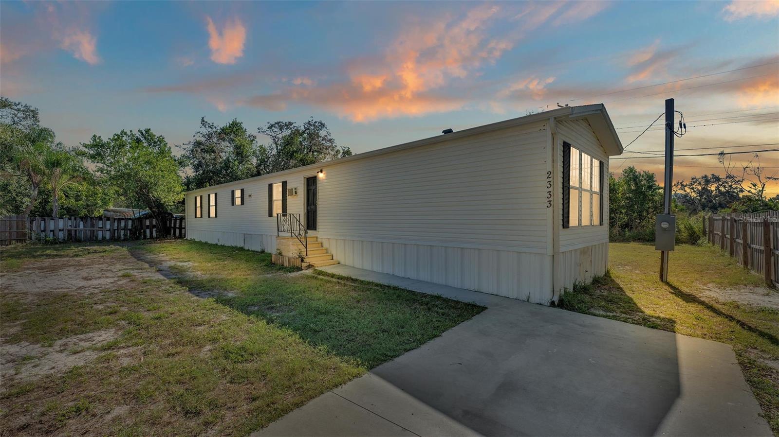 Under contract-accepting backup offers. Welcome to 2333 King Ave! NO HOA and you own the land! Sitting on .23 acres, this flat lot is completely FENCED! It features an open concept and split floorpan with 3 bedrooms and 2 bathrooms. There’s NO CARPET! The home features waterproof laminate flooring throughout. Step into the large primary suite that offers a walk-in closet. The en suite bath features a garden tub, separate shower stall, and double vanity. The guest bedrooms are roomy and share a hallway bath with a tub/shower combo. Both front and backyards offer enough space for pets and toys. Situated in between Auburndale and Winter Haven, you can enjoy a rural setting while still being close to shopping, dining, and more! Reach out today for your private showing! Seller is willing to entertain any and all requests written into offers submitted. Roof, HVAC- Approximately 2019