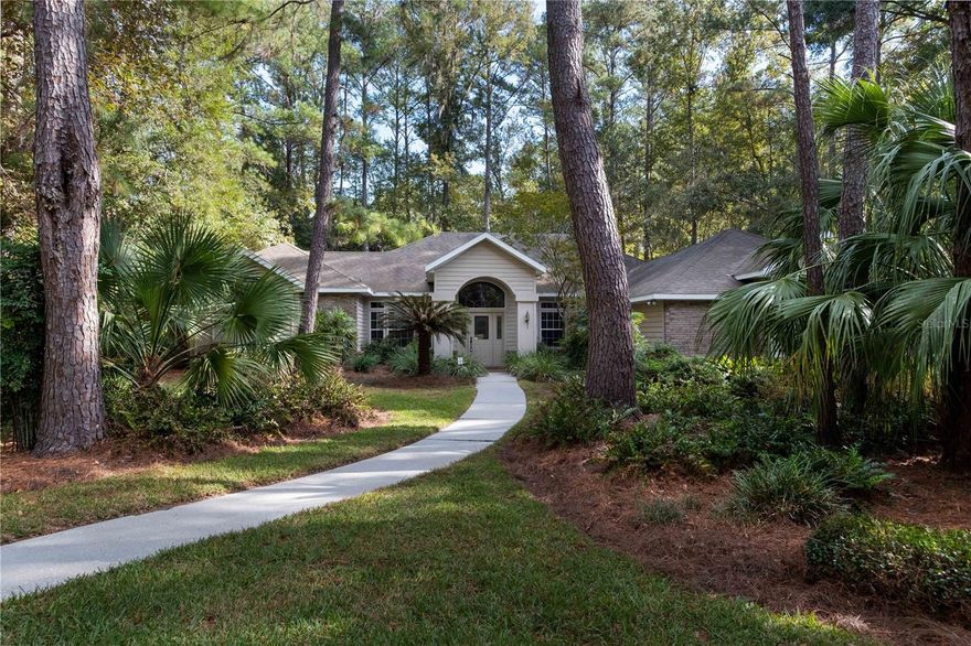 **Accepting backup offers** Welcome home to Richmond, one of NW Gainesville's most sought after neighborhoods! This beautiful home is situated on a wide 1 acre lot and nestled in the back of the neighborhood on a quiet cul-de-sac. The meticulously maintained landscaping and daily wildlife sightings create a peaceful oasis right in the heart of town. You'll appreciate the convenience of the Richmond neighborhood, just minutes from Millhopper Publix, Thornebrook Village, A-rated elementary, middle, and high schools, as well as a quick drive to I-75. The beauty of this home and neighborhood begin from the moment you turn in. A winding drive into the neighborhood causes you to relax your shoulders, exhale, and appreciate the surroundings as you approach your home. A welcoming sidewalk and an oversized driveway with a side entry garage provide the perfect hello for family and friends. The 4 bed/3 bath, 3-way split floor plan was well designed to accommodate a family and professionals working from home. As you enter the foyer, you'll appreciate the soaring 10' ceilings with tray ceiling details, recessed lighting, and a direct view of the large rear patio. Immediately to the left of the home is the spacious primary bedroom and bathroom complete with a soaking tub, a standing shower, a large walk-in closet, and a private entry to the back patio. The formal living room and dining room lead to the other side of the home where you'll appreciate a large open concept kitchen with a breakfast nook and a family room with 12' ceilings and a gas fireplace. Located in a private hallway just off the kitchen are two well appointed bedrooms and a full bath. At the back of home, located just beyond the family room, you'll find the 4th bedroom with an en suite bathroom and private entry to the back patio. The spacious back patio is screened and provides an abundance of space for relaxing in the beautiful Florida weather and watching the deer in the yard. The back patio was also intentionally designed to accommodate the addition of a pool for future owners. On the 1 acre lot you'll see a multitude of mature shrubs, bushes, trees, and fruit trees. That's not all, additional features include: brand new stainless steel appliances, new fixtures, built-in speaker system, 3-car garage, 2-zone HVAC, 2 water heaters, massive kitchen pantry, and so much more! This home is ready for a new family and the opportunity to live in Richmond doesn't come available often. *Buyer to verify all property details.*