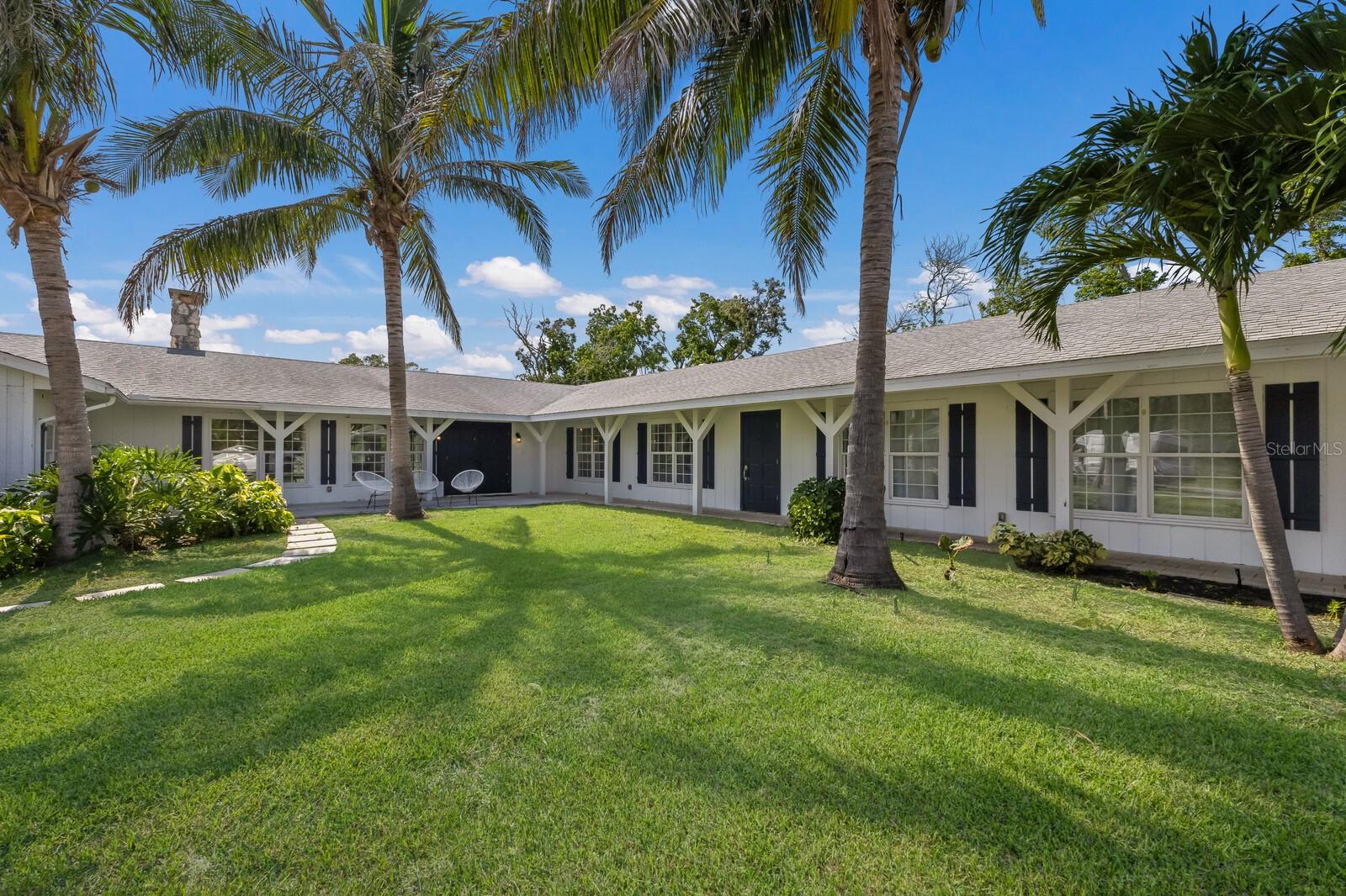 Do you have horses - or dream of having them - in Northwest Bradenton? Then this property is for you. Welcome to your dream farmhouse retreat! Nestled on nearly 5 acres just moments from the scenic trails and natural beauty of Robinson Preserve in Bradenton, Florida, this spacious four bedroom, four-bath estate offers the perfect blend of country charm and modern comfort.
Step inside to an inviting open floor plan filled with abundant natural light. The heart of the home is the stunning kitchen, complete with a farmhouse sink, high end appliances, a gas cooktop, and a large butcher block island with a one-of-a-kind eat-in dining area which is ideal for everyday living or entertaining. The kitchen flows seamlessly into the bright and airy living room featuring oversized windows, sliding glass doors, and a cozy wood-burning fireplace. The expansive primary suite is your private sanctuary, offering a large walk-in closet and a spa-like en-suite bathroom with plenty of room to unwind. Each additional bedroom is generously sized, and the four full bathrooms ensure comfort and convenience for family and guests alike. Outside, enjoy wide open spaces with room for a garden, animals, or simply soaking in the peaceful, pastoral setting. This property offers privacy and tranquility, yet it’s only minutes from the vibrant lifestyle of Bradenton. Explore kayaking, biking, and birdwatching at nearby Robinson Preserve, or spend your weekends enjoying the Gulf beaches, Anna Maria Island, and the shops and restaurants of downtown Bradenton—all just a short drive away. This one-of-a-kind farmhouse property offers the best of Florida living—space, style, and serenity. Don’t miss your opportunity to make it your own!