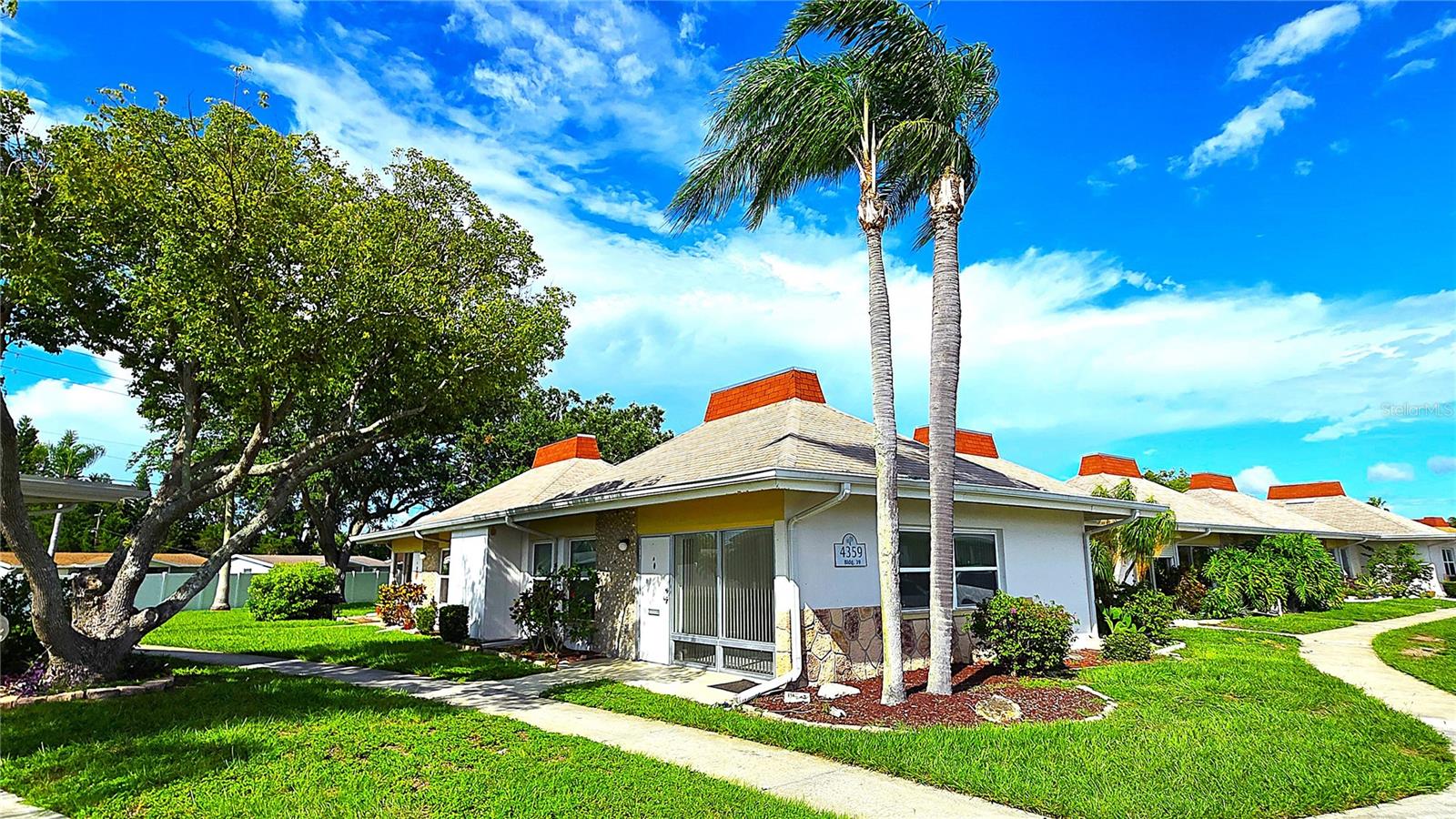 Welcome to this charming 2-bedroom, 1.5-bath corner/end-unit condo located in the highly desirable gated community of Tahitian Gardens! This delightful home is tucked away in a peaceful, low-traffic cul-de-sac offering both privacy and convenience. Best of all, there's no previous storm water intrusion and no flood insurance required!
Step inside and enjoy the bright, open floor plan featuring tile flooring throughout the main living areas. Floor-to-ceiling windows in the living room bathe the space in natural light, creating a cheerful, inviting atmosphere. The combined living, dining, and kitchen areas are perfect for entertaining or everyday living. The kitchen offers generous cabinet space to support all your culinary needs.
The owner’s suite includes a private half bath, while the full bathroom features a step-in shower/tub combo. A second bedroom provides a comfortable space for guests or a home office. Additional highlights include a 2024 HVAC system and a convenient in-unit stacked washer and dryer in a humongous laundry/utility room offering additional storage and closet space.
Outside, you’ll be welcomed by a lovely outdoor sitting area ideal for morning coffee or evening relaxation. And for total peace of mind, the HOA covers all exterior maintenance, ensuring a true maintenance-free Florida lifestyle!
Residents of Tahitian Gardens enjoy access to a wide array of amenities, including a heated pool, shuffleboard courts, walking trails, and a vibrant social calendar with activities like arts and crafts, bingo, cycling club, card games, and even a fully equipped wood shop. The clubhouse includes a full kitchen for community gatherings.
Located just minutes from the famous Tarpon Springs Sponge Docks, beaches, dining, shopping, golf courses, and area airports, this condo offers the perfect blend of comfort, convenience, and community.
Don’t miss your chance to own this lovely home in one of the area’s most active and friendly 55+ communities!