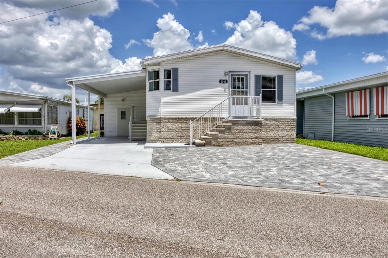 This light, bright and airy Double Wide manufactured home with vaulted ceilings offers Two bedrooms and Two baths, featuring open-concept living with a Single Family home feel on a slightly oversized lot. Move right into the highly desired, 55+ Trailer Estates community! Many recent upgrades. New Roof; new AC in 2023. New laminate flooring throughout in 2022. Spacious, open Kitchen with Island/Breakfast Bar including new refrigerator and kitchen sink/faucet in 2023. Primary Bedroom has ensuite bath and a wall to wall built-in closet. New toilets were installed in both baths in 2022. Laundry hookups both inside and in shed. New pavers in front. Huge 11 x 12 Shed. WDO tented in 2022 with transferable warranty. You own the land. Boaters have direct access to Sarasota Bay from the Marina. Enjoy the large, heated community pool, hot tub, gym and wood shop. The community buzzes with pickleball, shuffleboard, kayaking, horseshoes, bocce, dancing and more. A US Post Office on site. 10 minutes to Sarasota-Bradenton Int'l Airport. Convenient to shopping, restaurants, the Arts and everything in Bradenton/Sarasota.