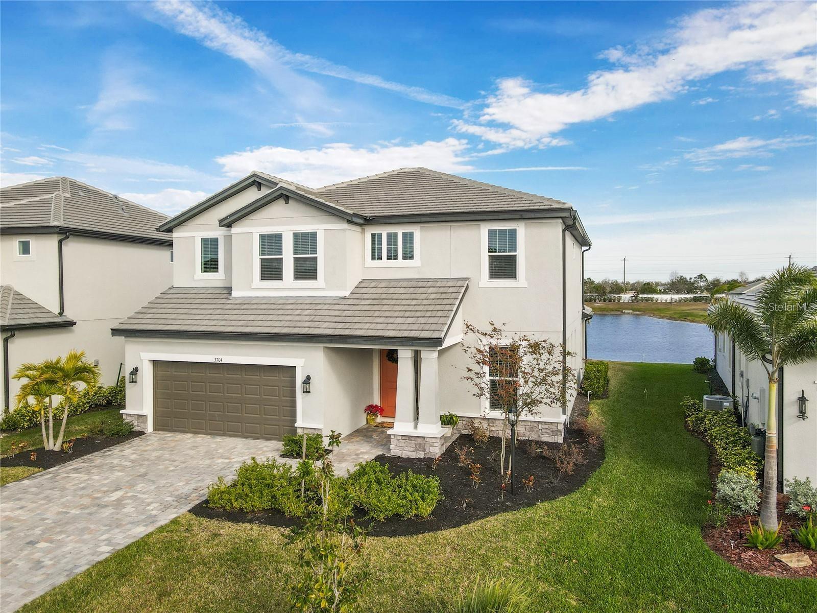 Welcome to this stunning 2023 built home with serene water view, offers an exceptional blend of modern luxury and practical design.The home offers 3 bedrooms, 2 ½ bathrooms, a den and a separate flex area, and a 2-car garage. Garage has more space beyond the 2-car for extra storage (9'x7'). Estuary is a unique design, and it begins at the front of the home. As you step inside the foyer, you are greeted with a flex area. You have the option to turn this area into a den with doors for a quiet home office space. Stairs also greet you in the foyer, leading to the second story. Stepping down the hallway, you walk into a spacious combination area with a great room, breakfast area, and kitchen. The kitchen sits off to one side with a full walk-in pantry, an incredible amount of countertop and cabinet space, and a center island designed for even more space and seating. By the breakfast area, sliding glass doors lead to a covered lanai with the option to extend. Walking up the staircase and into the second story, the space is open to below with a large loft. The master suite also takes up one side of the upstairs, creating a truly relaxing and private retreat. Step inside the tranquil master bath to find a water closet, enclosed shower area, and dual vanities with plenty of countertop space. A large walk-in closet is also a highlight of the master retreat. The laundry room also sits upstairs, giving you easy access to cleaning and organizing. Two bedrooms house walk-in closets of their own, and they share the upstairs with a bathroom containing dual vanities and a tub. Come visit the Estuary, a modern home for modern living.River Wilderness golf community has a boat ramp with access to the Manatee River.