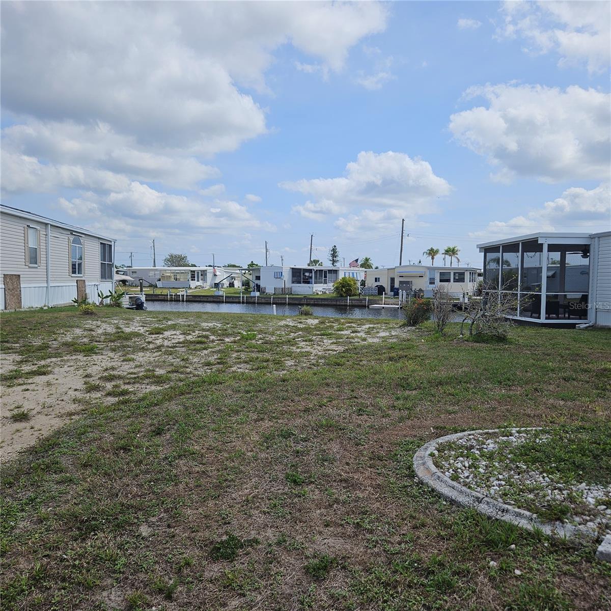 Build your new manufactured home on this beautiful gulf access waterfront lot in Harbor Cove.
Priced low to sell fast. There is a damaged dock that will need removed or replaced.
Monthly HOA fee is only $150. Pet friendly. Bring your boat! We can assist you with choosing a manufactured home builder.
Offering a private community boat ramp, 90 slip marina, two story clubhouse, two heated pools, hot tub, bocce, tennis, pickleball, fitness, storage grounds, wood working shop, crafts, dinners, dances, entertainment and more. Easy commutes to Sarasota and Fort Myers. Minutes from the gulf beaches, Myakka River, Peace River, Charlotte Harbor, restaurants, shopping, Tampa Bay Rays summer training stadium, Warm Mineral Springs Health Spa, Cool Today stadium for the Atlanta Braves, and the Allegiant Airlines SunSeeker Resort located in Charlotte Harbor. EVERYTHING you need for your waterfront lifestyle is here in Southwest Florida.