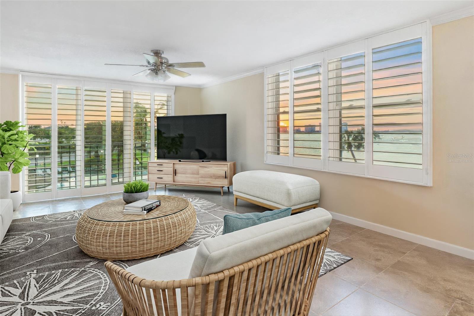 Enjoy breathtaking panoramic water views from this beautiful southwest corner unit at Belleview Biltmore Villas. This spacious 2-bedroom, 2-bath condo offers nearly 1,400 square feet of living space, plus a 180-square-foot screened-in balcony with unobstructed views of the Intracoastal and Harbor. Natural light pours into the open-concept living and dining area through a rare bonus corner window, making this one of the most desirable floorplans in the building. The interior has been tastefully updated with porcelain tile flooring throughout the main living areas, plantation shutters, crown molding, and smooth ceilings with no popcorn. IMPACT RATED doors and windows provide both safety and peace of mind. The kitchen features granite countertops, recessed lighting, stainless steel appliances, custom wood cabinetry with pull-out shelves, and a spacious center island with bar seating—perfect for both cooking and entertaining. Both bedrooms offer stunning water views and generous space. The master suite accommodates a king-size bed and sitting area, with double closets and direct access to the balcony. The en-suite bath includes a new granite vanity, walk-in tiled shower, updated lighting, and a linen closet. The guest bedroom is large enough for a king or two queen beds, making it ideal for flexible use. Step onto the oversized screened balcony and enjoy stunning sunsets, boat activity, and sparkling city lights at night. Additional features include: NEW water heater, 2024, a full-size washer and dryer, hallway storage, and a covered carport (space #301). Residents enjoy access to a heated waterfront pool, a large sundeck, a private clubhouse that can be reserved for events, and beautifully maintained grounds. Best of all, the building has passed its Milestone Inspection, with no structural integrity concerns—offering true peace of mind. According to the engineering report, there are no observed conditions that compromise the building’s safety for its intended use. This community is ideally located inside the gated Belleair Country Club, where social and golf memberships are available to condo owners, and close to beaches, dining, shopping, and grocery stores. Tampa International Airport is less than 30 minutes away. Don’t miss your chance to own this exceptional water-view condo—schedule your private tour today!