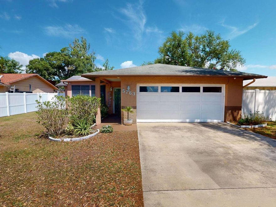 Fully updated and move-in ready 2-bedroom, 2-bath concrete block home with a spacious 2-car garage, located in a non-flood zone! The seller is offering a brand-new roof to be installed with an acceptable offer, providing added value and peace of mind. This well-maintained property features recently updated flooring, a beautifully upgraded kitchen with granite countertops and stainless steel appliances, and tastefully renovated bathrooms with new vanities. Enjoy additional living space with both an enclosed front porch with A/C—perfect for a home office or sitting area—and an enclosed back porch ideal for relaxing or entertaining. Conveniently located just minutes from Tampa International Airport, Downtown St. Petersburg, and the stunning Gulf Coast beaches, this home offers the perfect blend of comfort, updates, and location.