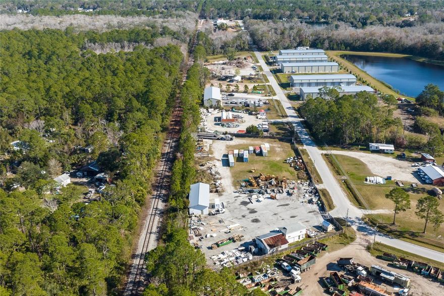 Time to buy the VERY LAST vacant Industrial Zone parcel in St. Johns County, Florida! 1570-1590 Northwood Dr. St. Augustine are two adjoining parcels totaling 2.28 acres. 96.5% of the property is vacant!!! This is the ONLY primarily undeveloped Industrial piece in the newly effective 2025 St. Johns County Land Use Plan (yellow on the Zoning Map). It is ideal for a new industrial or manufacturing facility. 1570 Northwood is 1.0 acre of level, dry vacant land. 1590 Northwood has a 1,971 sq.ft. masonry warehouse with a large roll-up door, and a 900 sq ft open masonry garage for storage. It also boasts a1,074 sq ft 2 story wood-frame office building with 1.5 baths and window A/C units. These buildings are situated on 1.28 acres of paved land and are prior non-conforming uses. The property is served by 200 amp-3 phase power, high-speed internet, and a deep well. The 2.28 acres are trapezoidal and fully fenced and perfect for industrial development. There are 3 gated openings onto344.56 ft of road frontage onto Northwood Drive. The rear of the property abuts a dedicated Florida East Coast Rail road spur. There are no environmental issues and a certified 2020 survey is available upon request. The property is located near Northwood Industrial Park and the new Commerce Park, with excellent access to Routes 207, 16, and the new Route 312Extension. Northwood Drive is just 5 miles to Interstate 95. Downtown St. Augustine is only 4 miles away and Jacksonville International Airport and its Seaport are within 50 miles. St. Augustine is the oldest city in the U.S., and is growing rapidly while maintaining that ‘home-town’ feel. The property has a month-to-month tenant paying $2,000 monthly using the Northwest corner for material storage and can remain during development. The vacant 2.28 acres is perfect for a 1031exchange. This parcel has huge potential and is the ONLY vacant land left dedicated for industrial development uses in the entire St. Johns County 2025 Use Plan.