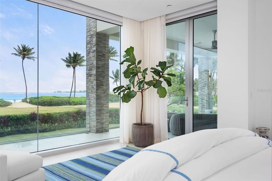 Supreme Beachfront Luxury in the St. Regis Bahia Beach Resort – Within Puerto Rico’s most exclusive resort, discover this move-in ready, coveted beachfront corner villa in the unparalleled Ocean Drive Residences. With 3 bedrooms and 3.5 bathrooms, sweeping ocean views, private salt-water swimming pool and jacuzzi, nowhere else will you find a more breathtaking property on the beach. Imagined by renowned architectural firm SB Architects and designed by global firm Hirsch, Bender, and Associates, premier luxury awaits you in every corner of this immaculate, fully furnished, turn-key condo. Floor-to-ceiling windows in every room maximize light and ocean exposures over the residence’s 4,777 square feet of gross living area.  Open plan kitchen and living room features jaw dropping views of Puerto Rico’s most beautiful half-moon white sand beach. The well-appointed Poliform Italian kitchen is outfitted with top-of-the-line Sub-Zero and Wolf appliances. A neutral color palette compliments the over-sized white quartz island and countertops. Custom cabinetry above the bar area makes for fabulous entertaining. The living area connects directly to the expansive covered terrace and dining area, boasting 1,400 square feet and including a state-of-the-art Wolf outdoor kitchen and grill. Outfitted with iPad synced SmartHome system, Lutron audio, and Sonos speakers throughout the home and pool area- every detail of contemporary luxury is considered. From the moment you wake, tremendous ocean views greet you from bed - the master suite features floor-to-ceiling hurricane proof glass walls. Step out directly onto the grand balcony and enjoy the ocean breeze. The enormous primary ensuite bathroom includes a standing tub, double vanity, and sauna showers. His-and-her closets have been outfitted by Italian brand Sangiacomo with custom lighting and mirrors. The same attention to detail transitions into the secondary suite where two full walls of glass line the bedroom. The standing tub in this ensuite bathroom features unique concentric circle design and sauna shower. The third bedroom suite features a unique back patio with a green wall maximizing privacy and perfect for taking in the sunsets or reading a book. Walk directly from your home out onto the enclosed pool and yard area or venture mere meters to the secluded white sandy beach, which stretches nearly 2 miles. Store your beach equipment or sports gear in the convenient 136 square foot storage included with the purchase. 

Bahia Beach is an outdoor lover’s paradise - residents can explore a host of lakes and rivers sprawling over its 400-plus acres. The resort is home to a Certified Gold Audubon International Signature wildlife sanctuary. Walk, jog, or bike along the nature trails that run throughout the beautiful grounds. Golf on an astonishing course, designed by renowned architect Robert Trent Jones Jr., with views of El Yunque Rainforest from nearly every hole. Tennis aficionados can choose either hardtop or clay courts. From the nearby Boat House, residents can kayak along the Espiritu Santo River, paddle board, catch-and-release fish, or sail. Dine in one of the many gourmet restaurants located at the hotel or visit the newly planted hydroponic garden - residents can order fresh organic produce delivered right to their door. This is luxury living at its finest. 
Property is sold with all furniture, 2 parking spaces, 1 electric charging station, a 2021 Tesla Model Y, and 6 passenger golfcart.