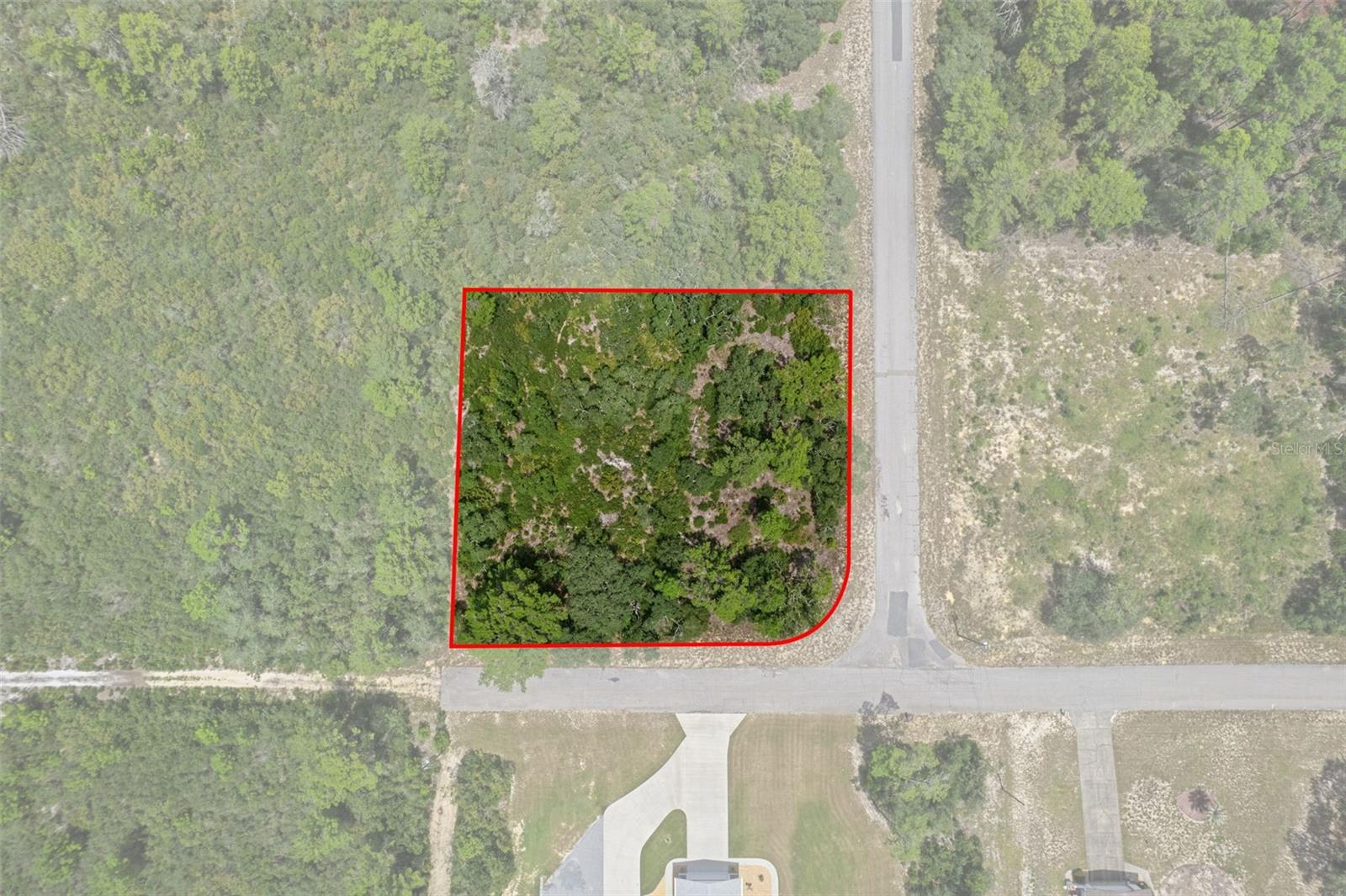 This beautiful corner lot in Citrus Springs is just OVER half an acre and offers the perfect blend of privacy and convenience. Situated on a paved road with very few homes on the street, and surrounded by woods, you’ll enjoy a peaceful setting without sacrificing easy access to everything you need. This property is not in a flood zone, has no HOA, and already has electric and public water available at the street. Located in a homes-only community (mobile homes not permitted), this lot is just minutes from US 41/N Florida Avenue, leading you straight to the famous Rainbow Springs State Park—home to crystal-clear, year-round 70 degree waters and scenic walking trails. The charming town of Dunnellon is nearby, offering shopping, dining, parks, fishing and more. Citrus Springs itself is a vibrant community with a golf course, schools, churches, doctor’s offices, tennis courts, baseball fields, a playground, a library, and access to the 46-mile Withlacoochee State Bicycle and Walking Trail. With no mandatory HOA and a prime corner location, this is the perfect spot to build your dream home.