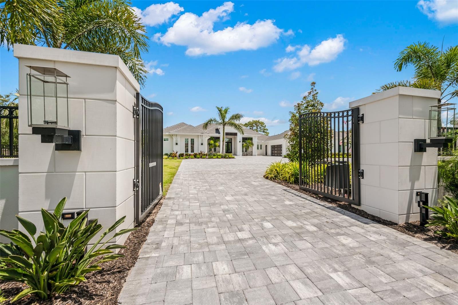 A stunning, brand new, fully custom home offered for immediate occupancy in the exclusive Concession Golf & Country Club. Based upon the floorplan of Kemick Builders’ multi-time Manatee/Sarasota Parade of Homes “Grand Overall” award winning home, this estate was custom-built and is available for immediate closing and owner occupancy. This beautifully landscaped property includes a full-length entry wall featuring gas lanterns, dual gates, and electronic video-enabled access. Abundant guest parking is available within the gates, as this property can host up to 10 guest vehicles without impeding traffic flow. The interior of the home incorporates high-end, top-of-the-line finishes throughout including luxurious wood floors, elevated ceilings with beams, and tongue and groove accents. Additional features include Savant control systems, distributed lighting, audio and video, R-30 encapsulated insulation, Low E windows, multi-zoned air conditioning with dehumidifier and an 80kw whole house generator. The dining room overlooks the massive rear lanai and features a custom, secure, and temperature-controlled wine cellar. Additional wine storage is accessible with built-in, double wine refrigerators adjacent to the butler's pantry. The kitchen highlights a Viking appliance package to include a six-burner gas range; dual dishwashers; built-in refrigerator; built in Advantium convection microwave oven; and a Thermador built-in coffee maker. The utility room features an additional refrigerator, elevated washer and dryer, built-in ironing board, and elevated dog shower. This home’s primary suite provides private access to the exercise room, study, and collector’s garage. The primary bedroom features beautiful ceiling and trim details, as well as a spacious adjacent sitting area. The primary bathroom includes dual vanities, lighted mirrors and makeup area, and a Toto bidet toilet. The massive walk-in shower incorporates a soaking tub and rain head shower along with dual facing shower systems. Adjoining the shower is a screened and private outdoor shower area. Dual walk-in closets highlight custom built cabinetry with integrated lighting, solid surface countertops and charging stations. One closet serves as a “safe room,” incorporating a vault door adhered to its reinforced concrete walls and roof. Guest suites each contain their own walk-in closets, ensuite bathrooms, and sliding glass doors leading to the courtyard. The covered and screened guest courtyard showcases an 8’ high privacy wall with waterfall and fountain. This area also features a suspended swing overlooking the fountain’s LED lighting and a 4’ linear fire feature. Adjoining the main lanai and pool area, the attached 2-bedroom/2-bathroom casita provides a separate, but inclusive space for additional guests. This fully independent space comes equipped with a full kitchen, dining area, living room and laundry area. This home’s expansive rear lanai allows preserve views complimented by multiple well-defined seating and dining areas. The outdoor kitchen showcases a grill, pizza oven, sink and icemaker. A private cabana with built-in water curtain, overlooks the pool and built-in spa. The collector’s garage, features tiled flooring and beautifully cladded accent walls. Its metal ceiling and directed lighting accents a rotating display table for your vehicle. Each garage features air conditioning, side-mount openers, and high-lift tracks.
