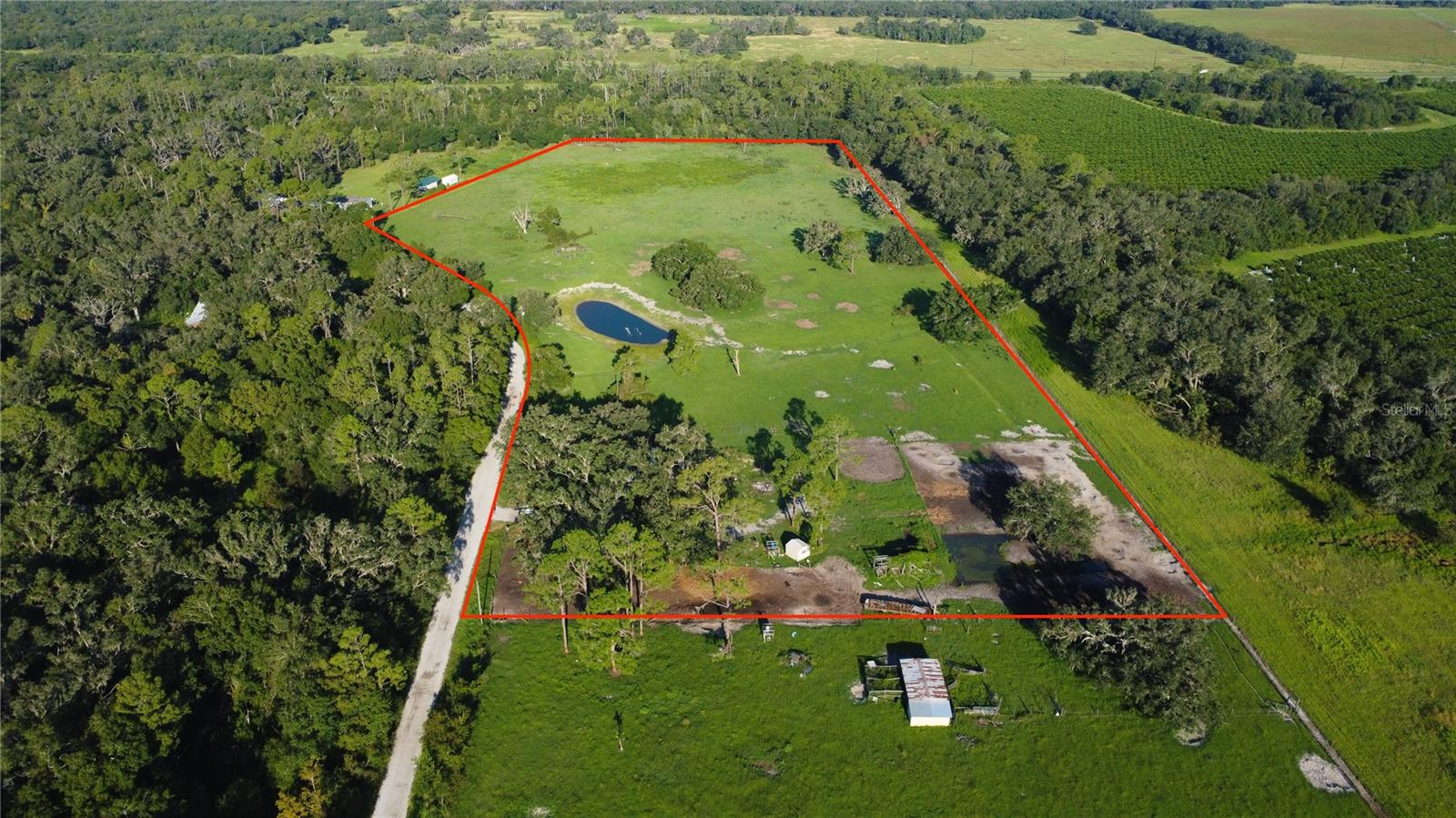 Escape to your own private retreat with this 15-acre agricultural property, perfect for cattle or horses. Tucked away on a privately maintained road, this secluded estate offers the peace and space you’ve been looking for, surrounded by beautiful large oak trees and wide-open land. The property features a 3 bedroom, 2 bathroom manufactured home with a desirable split floor plan, an indoor laundry room, and a 2023 metal roof for lasting durability. The land is fully fenced and cross-fenced, making it ready for livestock or equestrian use. With plenty of room to roam, this property combines country charm with practical improvements—ideal for those seeking a quiet lifestyle while keeping animals, farming, or simply enjoying wide-open spaces.