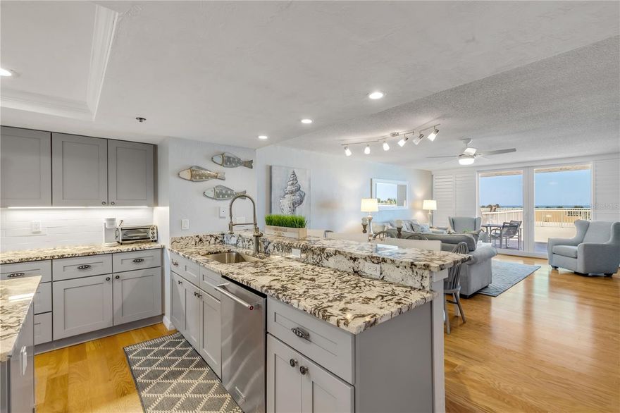 This tastefully renovated oceanfront condo home with views of the water and beach will please families with pets with it's ease to walk out to the patio and to the beach or pool.  This condo home comes turnkey - beautifully furnished and has great rental income potential.  Some upgraded features include granite, wood-style flooring and stainless steel appliances.  The beach life and entertaining come easy with the huge 31x45 foot balcony with amazing views from the kitchen, living area, and master bedroom.  The oceanfront community of Minorca is one of the most desireable complexes in New Smyrna Beach.  It offers 24-hour security, on-site management/office, multi million dollar clubhouse, 4 lighted Har-Tru tennis courts, private poll for Inlet Building, spa & saunas, beach access with oceanfront pavilion and gated river access to fishing pier and boat docs.