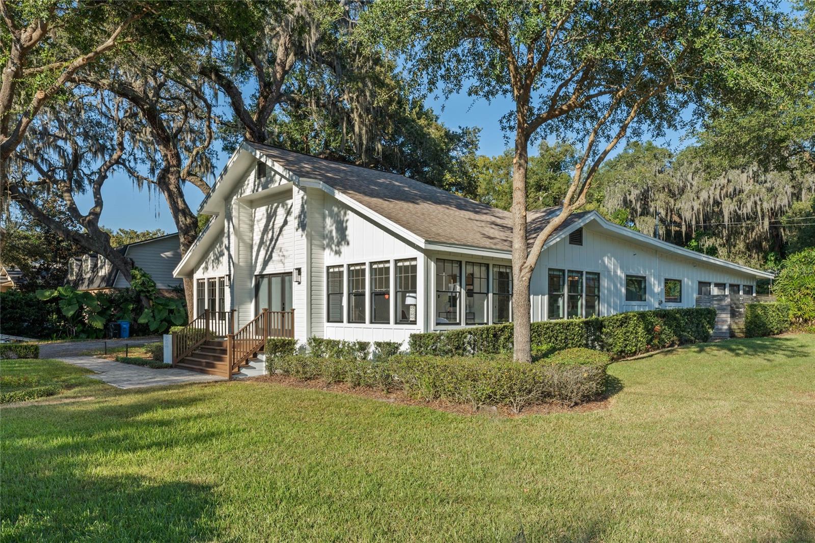 Under contract-accepting backup offers. Prime Downtown Windermere Corner Lot with Lake Views and Endless Potential. This beautiful home sits on a generously sized 0.38-acre corner lot with a very private backyard, offering incredible versatility. Whether you’re looking for a move-in-ready residence or the perfect location to build your dream home, this property is ideal. Builders take note: this lot can accommodate a new home up to 5,500 square feet with spectacular views of Lake Butler across the park and easy access to the Fernwood Boat Ramp. Downtown Windermere Charmer on an Expansive Lot with Stunning Lake Views Nestled in the heart of Downtown Windermere, this stunning three-bedroom, three-bath home blends traditional small-town charm with modern conveniences and rarely available space in the heart of downtown. From the front porch and the primary bedroom suite, enjoy picturesque views of the Butler Chain of Lakes, a constant reminder of the serene lifestyle this location offers. Home Highlights: Open floor plan greeted by a double-height foyer, creating a welcoming and airy ambiance. Main floor primary suite with custom California Closets, a charming clawfoot tub, and updated walk-in shower for ultimate comfort and privacy. Light-filled home office just off the foyer, surrounded by windows. Gourmet kitchen with brand new Bosch and Samsung stainless steel appliances, solid wood cabinetry, and granite countertops. Two additional spacious bedrooms, each with their own private bathrooms for convenience. Smart lighting with dimmers and modern fixtures throughout the home. Well-appointed laundry room with stackable Whirlpool washer/dryer, a utility sink, and custom cabinetry. Outdoor Living at Its Best: Oversized screened-in patio with ceramic tile, a wet bar, and ceiling fans, perfect for year-round entertaining or relaxation. Expansive private backyard oasis, featuring mature landscaping, wood privacy fencing, and abundant space for expansion or customization. Detached two-car garage with HVAC, electrical, a storage room, and a new well water treatment system—ideal for a studio, workshop, or office. Prime Location: This property offers a rare combination of space and convenience, with its 0.38-acre lot—a true gem in Downtown Windermere. Located along tree-lined dirt roads, it’s just a short stroll to Main Street's charming shops, eateries, and serene community atmosphere. Don’t Miss This Opportunity Whether you’re ready to enjoy this charming home or envision building a custom residence to take full advantage of the lake views and prime location, this property offers unparalleled potential.