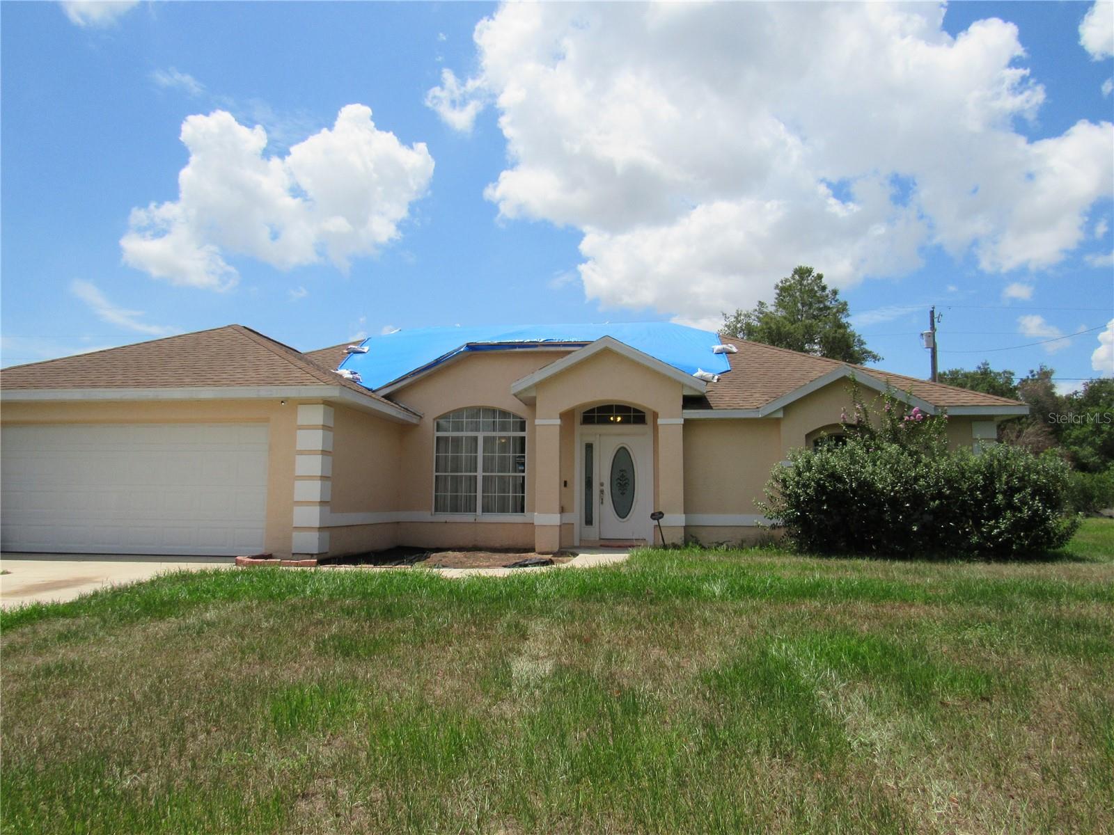 Welcome to this charming and spacious 3-bedroom, 2-bath home in the heart of Marion Oaks. From the moment you step inside, you’ll be greeted by a grand living room featuring high vaulted ceilings and an open-concept design that flows seamlessly into the dining area. A stylish arched entryway leads you into the kitchen and adjoining family room. The kitchen is truly the heart of this home—centrally located and open to both the living and family rooms, it boasts newer appliances, an oversized pantry, abundant counter space, and room for a breakfast nook. Sliding doors have easy access to the covered back patio, making indoor/outdoor entertaining a breeze.
The family room, currently used as a playroom, is filled with natural light from large windows that overlook the spacious backyard. Adjacent to the kitchen is a convenient laundry/mudroom—perfect for families providing a functional drop zone for shoes, backpacks, and everyday gear. The master suite is thoughtfully positioned in its own private area of the home and offers direct access to the patio through sliding glass doors. The ensuite bathroom features a large walk-in closet, dual vanities, a walk-in shower with natural light, and a private water closet. Enjoy the freedom of NO HOA and NO AGE RESTRICTIONS. This well-designed home combines functionality, space, and comfort and with a LITTLE TLC will be perfect for a growing family or anyone looking to enjoy the Florida lifestyle.