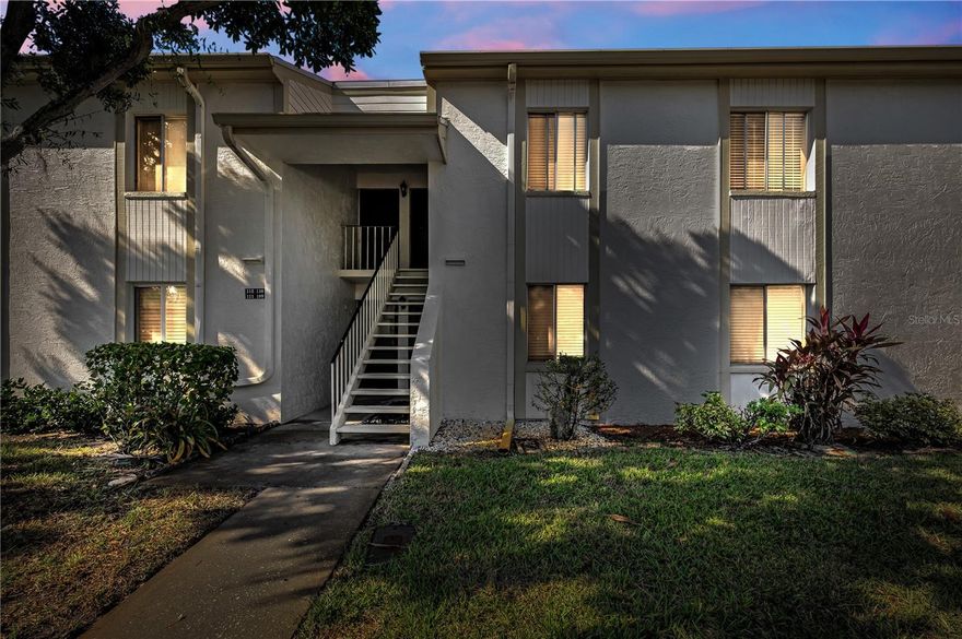 Welcome to a condo that instantly feels like home the moment you walk in, beautifully updated and meticulously maintained in the highly sought-after guard-gated East Lake Woodlands community. Light, bright, crisp and spotless, this 2-bedroom, 2-bath home feels truly move-in ready.

The kitchen steals the show with solid wood cabinetry, quartz countertops, new porcelain tile flooring, stainless steel appliances, ample storage with a coffee bar area, a large pantry closet, a breakfast bar, and an updated tray ceiling with LED lighting that gives the space a fresh, modern glow. Gorgeous laminate flooring flows through the main living areas, creating a cohesive, stylish look. The open living and dining area leads to your private screened balcony overlooking peaceful greenery.

The primary suite offers two walk-in closets and an updated en-suite bath with quartz countertops. The guest bedroom is comfortably sized, and the guest bath is bright, clean, and updated as well.

Additional features include 2023 LG front-load washer and dryer, newer lighting and fixtures, and a building roof that was replaced two years ago. Your covered carport is the very first space closest to the entrance. Every inch of this home reflects careful upkeep. Homes with this kind of warmth and care are rare. You feel it the moment you walk in.

If desired, the condo can be sold fully furnished, turn-key, allowing you to move right in and start enjoying the Florida lifestyle on day one.

Residents of East Lake Woodlands love this community for its natural beauty, walkability, and convenient access to everything Tampa Bay offers. Enjoy two heated community pools, scenic walking paths, and the option to join Ardea Country Club with championship golf, tennis, pickleball, fitness, resort-style pools, dining, and year-round activities. This pet-friendly community is perfect for you and your furry friends.

Prime location: minutes to Tampa International Airport, pristine Gulf beaches, scenic bike trails, parks, shopping, Westfield Countryside Mall, restaurants, entertainment, and the charming downtowns of Dunedin, Tarpon Springs, and Safety Harbor. No flood insurance required (Flood Zone X500).

Monthly dues include exterior maintenance, cable, internet, water, sewer, trash, and roof maintenance.

Clean, updated, and ready to enjoy, this condo feels good the moment you step inside and stands out as the kind of well-kept home buyers instantly appreciate.