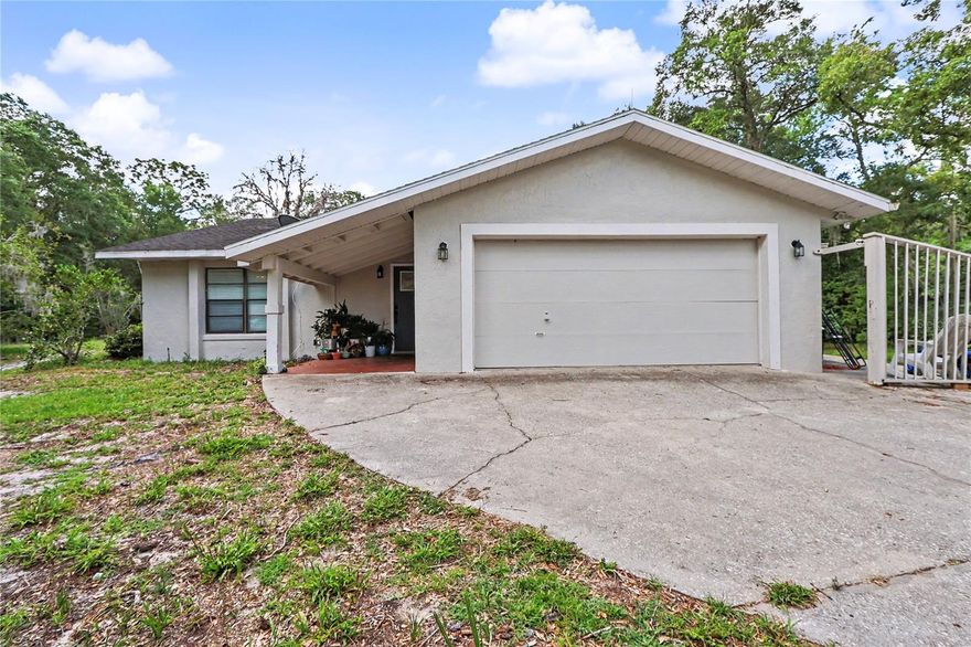 Welcome to Rainbow Springs – The Woodlands, where space, comfort, and versatility come together on just over an acre of beautifully maintained property! This updated home offers nearly 2,300 square feet of living space with 3 bedrooms, 2 bathrooms, and a 2-car garage, all tucked away in one of Dunnellon’s most desirable communities. A standout feature of this home is the oversized master bedroom which is currently being utilized as a private mother-in-law suite, complete with its own entrance, kitchenette, and cozy fireplace — perfect for extended family, guests, multi-generational living, or even a private retreat space. The heart of the home is the completely remodeled kitchen featuring stunning wood cabinetry, stone countertops, stainless steel appliances, and an impressive industrial-sized refrigerator/freezer combo that is sure to impress anyone who loves to cook or entertain. The indoor laundry room offers an abundance of storage space along with a convenient utility sink, making everyday living both functional and organized. Step outside to the beautiful paver back deck, the ideal setting for outdoor gatherings, weekend BBQs, or simply relaxing and enjoying the peaceful surroundings. Even better, this home is located within a low HOA community at only $243/year, while still offering incredible amenities! Residents enjoy access to a private beach on the crystal-clear Rainbow River, clubhouse, restaurant, community pool, fitness center, and scenic walking trails — making it easy to enjoy the Florida lifestyle year-round. With generous living areas, updated finishes, and a serene setting surrounded by nature, this property offers the perfect blend of privacy and convenience while being just minutes from shopping, dining, and all that Dunnellon has to offer.