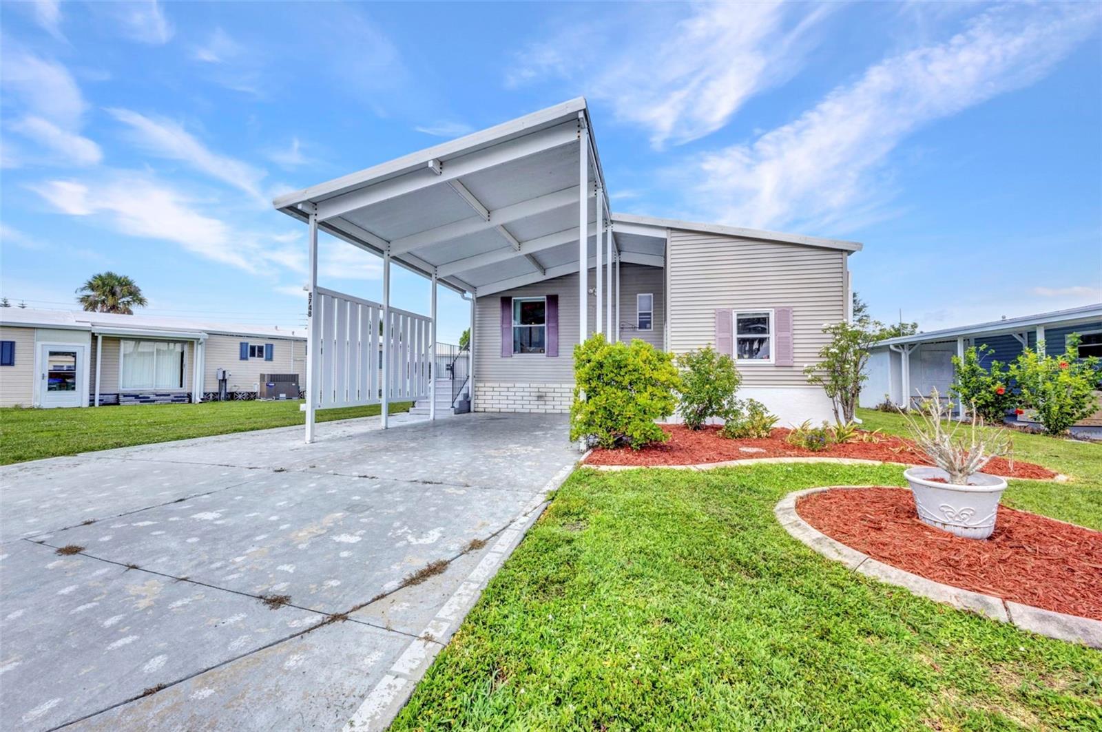 Welcome to 5748 Holiday Park Blvd. This home is located in the gated community of Holiday Park in sought after North Port, FL. It is turnkey & has 3 bedrooms with 2 full bathrooms, dining area as well as a large open living room and a kitchen with eating area and inside utility closet. This home is in the PET SECTION of Holiday Park and also has a nice size shed/workshop. In Holiday Park you own the land with a deed and your monthly maintenance charge of $195 ($2340 yr) is included in your taxes. The community features 2 clubhouses, 2 swimming pools, a library, fitness center, tennis courts, pickle ball & bocce. You are close to shopping, restaurants, entertainment, numerous golf courses, sports facilities, airports and beautiful FL beaches.