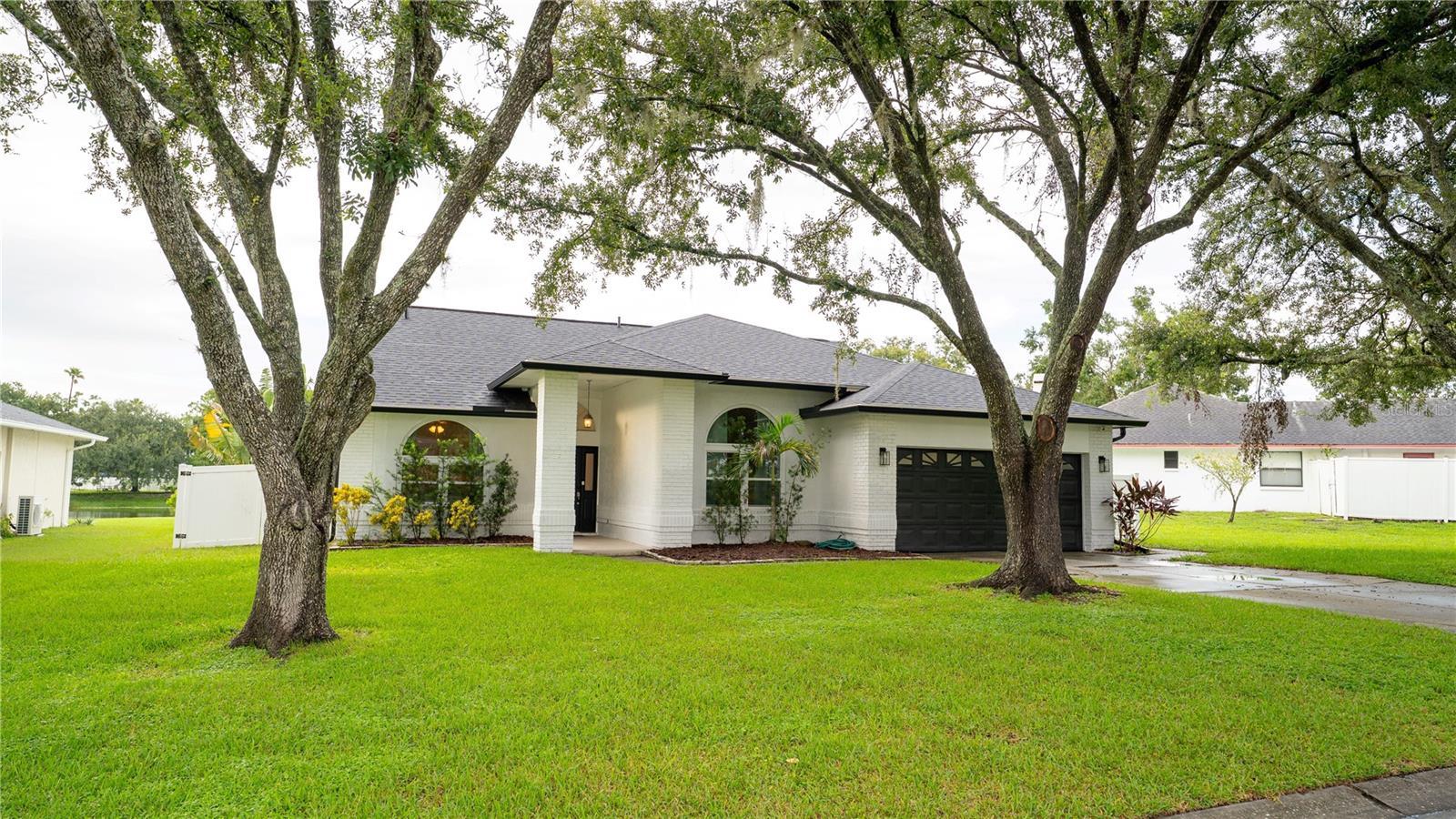 Updated pool home on over a quarter acre lot with pond views! Nestled in Lake Padgett Estates East, this property has been tastefully updated with attractive improvements all over. The list includes a new roof in 2023, brand new impact windows just done in 2024 and LVP floors throughout the entire home in 2022. The heated saltwater pool is barely 6 years old and comes with it all: attached spa, sun shelf, 2025 chlorine generator, umbrella, night lights and a full-size gazebo only feet away. Florida living at its best! The house itself is spacious as well, nearly 1,800 sqft with a master suite and large walk-in closet, two separate bedrooms to complete the split floor plan, and a bonus room off the dining area that can be used as an office, extra bedroom or storage. A wood burning fireplace might not be used too often but offers the holiday ambiance that families love to decorate and make memories around. The kitchen comes with stainless appliances, wood cabinets and tasteful countertops which looks out to the pool deck. The laundry room sits behind the kitchen right before you step into the full size two car garage. The community amenities include a pool, tennis court, park, gym and club house. Enjoy shopping, dining, the premium outlets, medical facilities and schools that are all only minutes away. I75 and the Suncoast Parkway are nearby for a quick commute to downtown Tampa, Tampa International airport and our world-famous beaches! Priced to sell so come make an offer today!