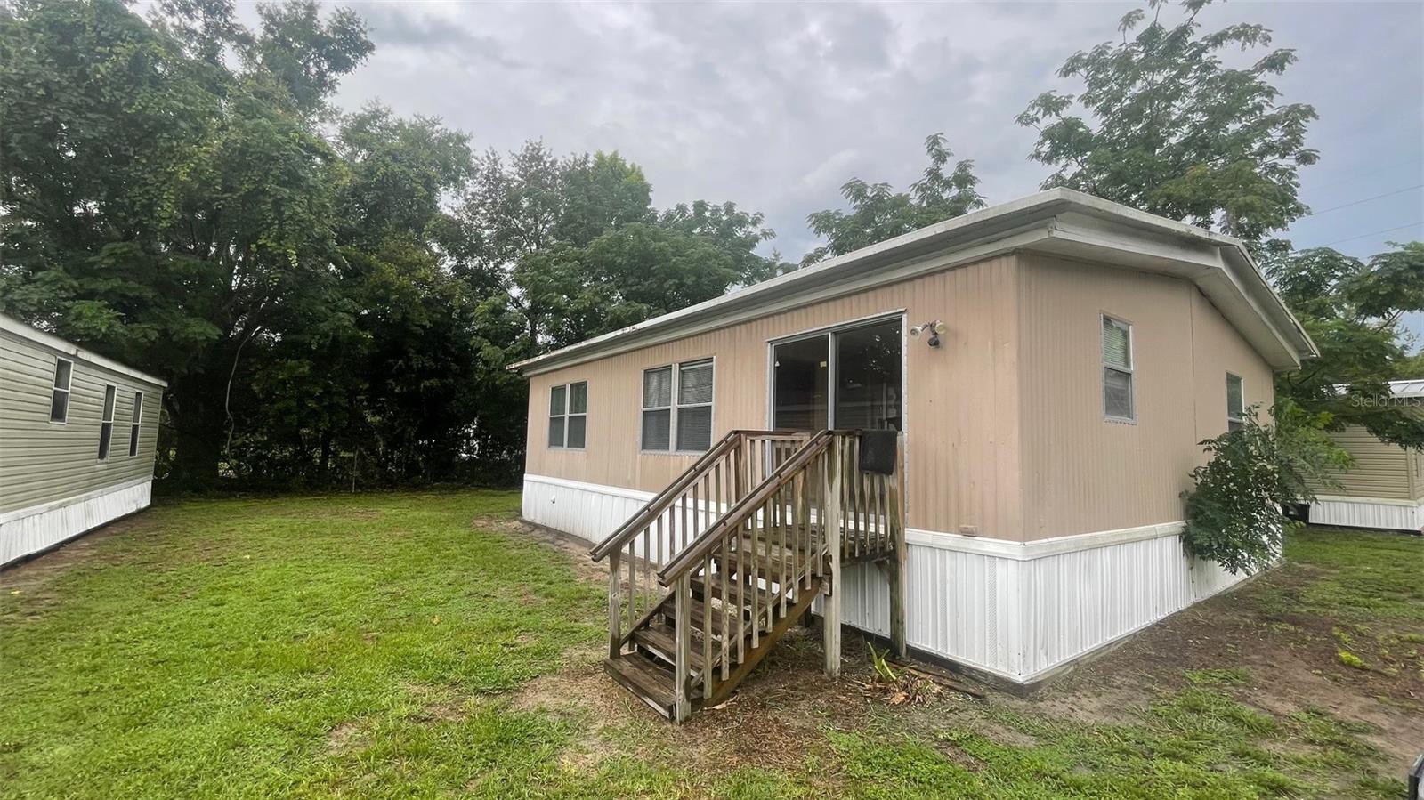Great location, near The Villages! 2 bedroom/2 bathroom doublewide mobile home is located in a small Belleview mobile home park. Dining room, living room with cabinets. Primary bedroom has large closet and bathroom with walk-in shower. 2nd bath with tub/shower. Carpet and vinyl flooring. Rent includes water, septic, trash, and lawn maintenance. Appliances include a stove, and dishwasher. Refrigerator not warranted. Schools: Belleview Elementary, Middle, and High. All applicants must view the property. All applicants over the age of 18 that will be residing in the property must submit an application and sign lease. Proof of income required $2,625 month. 1st month and security (650+ credit score is $1,050 security deposit. 600-649 credit score - we work with low credit. Application fee is $125 1st adult and $50 each additional adult. NO DOGS AND NO SMOKING.