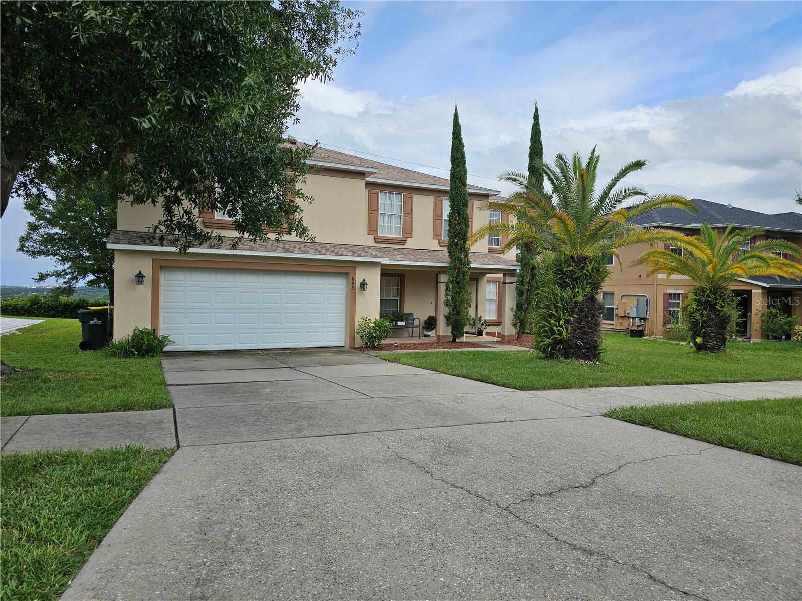 Located in the sought-after community of Skyridge Valley, this 4-bedroom, 3.5-bath home with an additional loft offers plenty of space for comfortable living. Its central Clermont location places you minutes from shopping, dining, schools, and major highways. A charming covered front porch welcomes you inside, where the foyer opens to a formal living room and formal dining room—perfect for entertaining. The layout flows into the expansive tiled family room, complete with an under-the-stairs storage closet. The spacious kitchen overlooks the family room and features granite countertops, abundant cabinetry, a breakfast bar, adjacent breakfast area, and an enormous walk-in pantry. Upstairs, a carpeted loft offers flexible living space and includes a large storage closet, with a Jack and Jill bath connecting to one of the bedrooms. All secondary bedrooms are generously sized, carpeted, and have oversized closets. The primary suite is truly impressive, featuring a massive bedroom area and a luxurious bathroom with granite counters, dual sinks, a garden tub, separate shower, and an extra-large walk-in closet. From the back of this home, you’ll enjoy an ever-changing masterpiece of natural beauty — sweeping vistas that stretch across the horizon, capturing glowing sunrises and sparkling evening skies. Whether you’re sipping morning coffee on the patio, hosting friends for sunset cocktails, or simply relaxing in your family room, the view serves as your backdrop year-round. Tandom 3 car garage allows for additional storage This home offers room for everyone and is situated in a prime location—don’t miss the chance to make it yours!