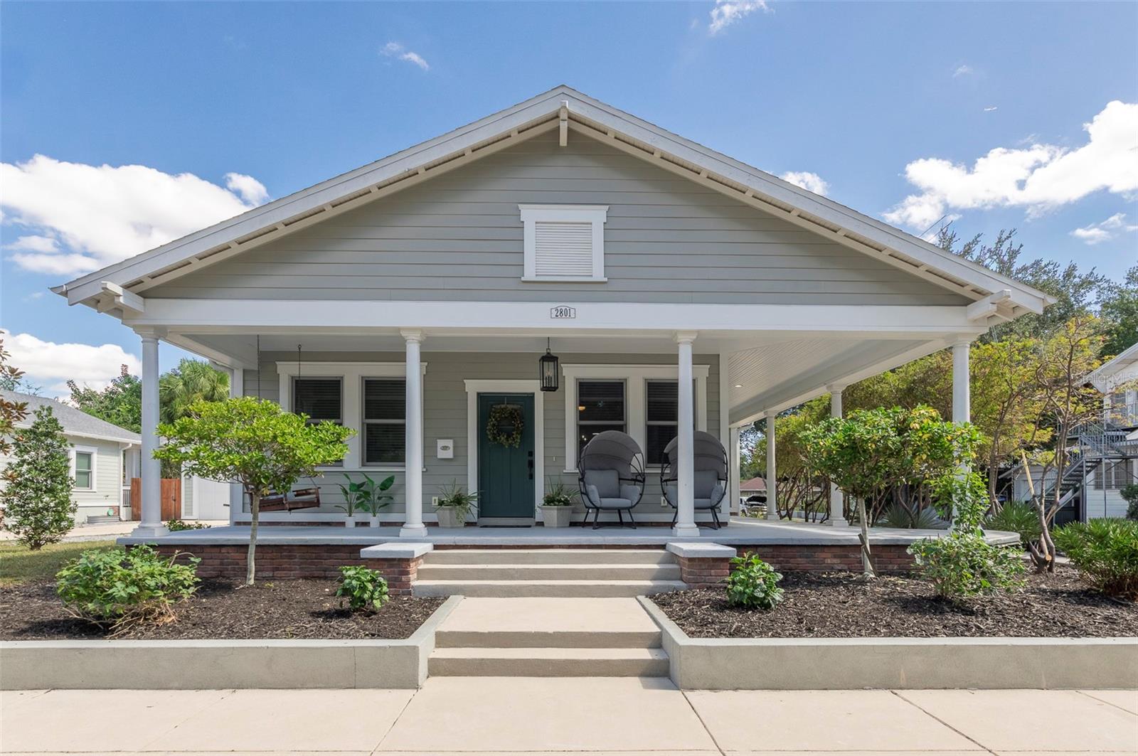 Love the history of Ybor City, but desire a newer build with a garage? This classic-looking Craftsman bungalow, centrally located within the Local Ybor Historic District in V.M. Ybor, is waiting for its next owner! Situated one block away from Elevenses Bakery, and only minutes from La Segunda, 7th Avenue in Historic Ybor, the TECO Streetcar, Gasworx, Water Street, Channelside, Tampa Armature Works, The Riverwalk, and downtown Tampa, you can’t beat the location of this hidden gem! Built in 2021 and located safely out of a flood zone, this home was designed to meet the current wind code, and has hurricane impact windows and doors. When walking up to the home, you’ll be greeted by mature landscaping and a large L-shaped front porch, great for enjoying your morning coffee on the porch swing while listening to the birds, or watching the sunset with a glass of wine. The light and bright open floorplan provides ample space for entertaining, or to relax while appreciating the tall ceilings, high baseboards, and decorative window and door trim. The living and dining room area opens to a large kitchen, perfect for the home chef with its expansive counter space in a neutral tone, classic large, white subway tile backsplash, tall white shaker cabinets, large pantry cabinet, single-basin sink, and gas range. The kitchen boasts a breakfast nook with a built-in bench, perfect for casual dining. The large primary suite offers two walk-in closets, as well as a zero-entry, oversized shower stall and dual sinks in the primary en-suite bathroom. The front bedroom is currently set up for use as a home office, and can easily be converted by a new owner for use as a third bedroom. The extra deep garage provides additional space for your weekend projects, while also accommodating a vehicle. V.M. Ybor is a community-oriented neighborhood, providing lots of opportunities to get to know your neighbors, as well as to learn about the area’s rich history. Don’t miss your chance to be part of this wonderful neighborhood and book your showing today!