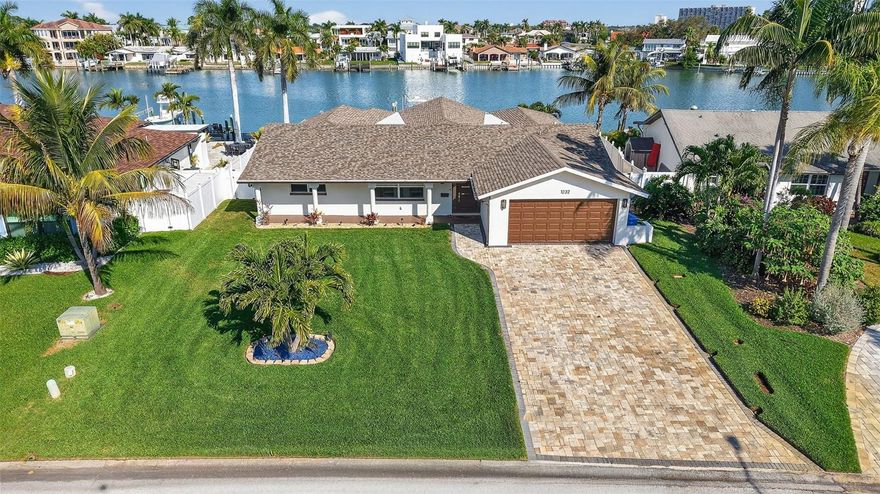 Welcome to this beautifully rebuilt 2021 coastal home in highly sought-after Yacht Club Estates. Essentially new inside and out, this 4-bedroom, 3-bath ground-level residence offers the rare advantage of not flooding during Hurricane Helene, thanks to its naturally elevated homesite.

Enjoy the convenience of true walk-out living where you can step directly to the pool or bring groceries in without stairs, all while having proven storm protection. The home features hurricane-impact windows, electric hurricane shutters across the back, natural gas, a full-house generator, and luxury coastal finishes throughout. One of the bedrooms serves as a private mother-in-law suite, providing ideal flexibility for guests, extended family, or a separate home office.

Perfect for boaters, the property offers sunrise waterfront views, a new elevated seawall, a composite dock, and a 20,000-lb boat lift—providing quick, easy access to the Intracoastal and Gulf.

Located in the back of the neighborhood where utilities are buried, this home blends modern construction, storm resilience, and effortless coastal living. Priced to sell—come check it out fast!