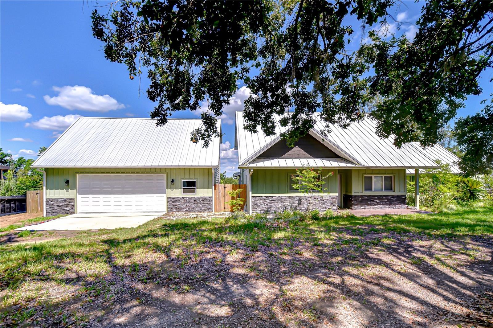 Your Private Country Escape in Beautiful Dade City! Assumable VA low interest loan below .04. If you’ve been dreaming of life just outside the hustle and bustle of the city, where space, freedom, and comfort come together, this Dade City home sits on 4.93 acres of gorgeous land and is ready to welcome you. With over 2,000 square feet of living area, this charming two-story, three-bedroom, two-bath home offers the perfect blend of function and flexibility. As you step inside, you'll immediately feel the warmth of the open living and dining area—designed with entertaining in mind. The spacious kitchen provides plenty of room for cooking, gathering, and everyday living, making it the heart of the home. The master suite is conveniently located on the first floor, offering privacy and ease of access, while the two upstairs bedrooms are exceptionally large, ideal for family members or guests who appreciate their own space. Fresh exterior updates give the home a crisp, clean look, and the metal roof adds lasting durability. Out back, a screened porch invites you to relax while overlooking your private in-ground pool—perfect for cooling off on hot Florida afternoons or hosting weekend get-togethers. The property continues to impress with a huge detached two-car garage and an adjoining unfinished upstairs studio space. Whether you're working from home, dreaming of a guest apartment, or envisioning a creative studio, this flexible area is ready for your personal touch. A sturdy barn with a covered area adds even more value, offering room for animals, equipment, or hobbies. This home offers endless possibilities. Whether you're bringing the whole family, a few furry friends, or simply your vision for a more peaceful lifestyle, you’ll find the space and setting here to make it all happen. Come see what country living in Dade City can truly be—this could be the home you've been waiting for.