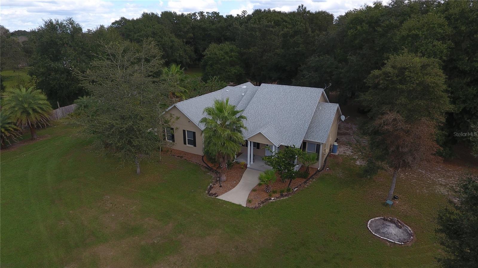 FLORIDA DREAMING ! Lake front home on pristine Lake Erie, 10+ acres. No HOA or CC&R's. Nature lovers dream, woods, water, wildlife, acreage and privacy. Custom home- 4 bedrooms, 2 bathrooms, open floor plan, large primary suite with gorgeous soaking tub/separate shower. Beautiful custom cypress woodwork on the front porch & lanai ceilings and much more. Enjoy one of Florida's finest pristine and private lakes right out your back door via the 350 ft nature walk winding through the 100' cypress trees leading out to your very own private dock and fishing pier. In addition, there is a 20 x 16 pole barn, private pond stocked with fish, shopping, attractions and major highways are in proximity and makes this property a rare and unique find that most of us only dream about. This is a must see before it's gone.