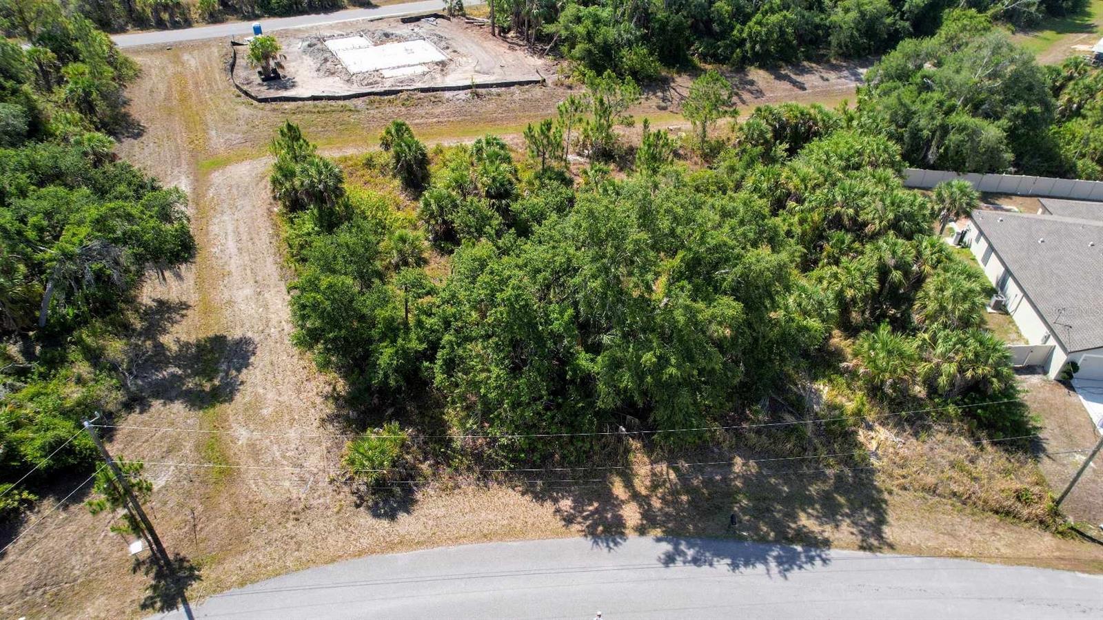 This oversized lot is a prime opportunity for building the home you've always envisioned. Nestled in an area experiencing a surge in new builds, this property boasts a unique feature – it backs up to a strip of land from a 3.3-acre parcel, offering a serene and private greenspace behind and to the left of the lot. Say goodbye to HOA fees and deed restrictions, as this property provides you the freedom to customize without limitations. Enjoy the convenience of being approximately 2 miles away from a plethora of shopping and dining options, ensuring that your everyday needs are easily met. For those seeking outdoor adventures, this location is a paradise. With numerous beaches just 20 miles away, you can indulge in boating, fishing, golfing, or simply relaxing by the shore. Whether you're a water enthusiast or prefer the greens of the golf course, this area caters to all your recreational desires. As of 01/19/2024, the property is not on the North Port Scrub Jay ID list. However, it's recommended to confirm this during your due diligence period to ensure there have been no changes. Seize this opportunity to create your haven in a growing community, surrounded by nature, convenience, and endless possibilities. This lot is a must see!