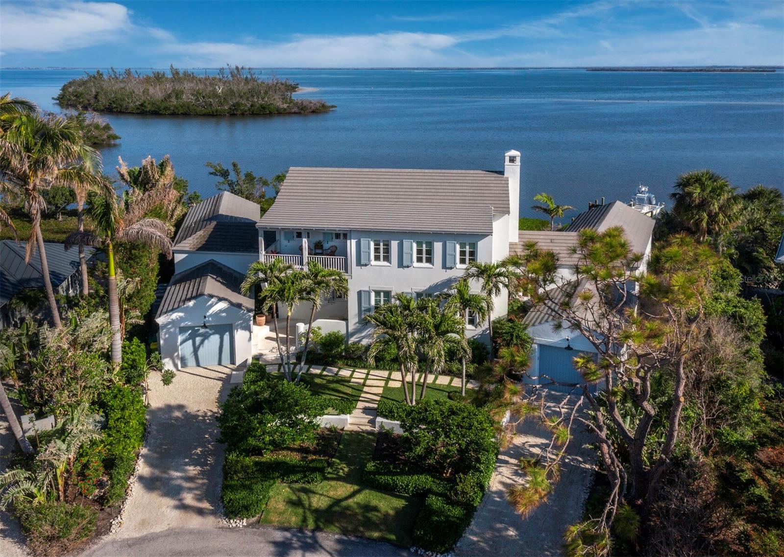 Tucked away in the northern end of Boca Grande Isles, 1824 Jack Point Lane pairs a one of a kind setting with wonderful design, detail and quality. Situated on 150ft of waterfront with views idyllically framed by the protected land of Hoagen Key and Three Sisters, this home provides an unmatched level of privacy and tranquility.
Completed in 2019, it captures the classic old Florida feel with stucco over cinderblock construction, old growth cypress inside and out, working shutters, a 2,200 sq ft custom terrazzo patio and hand crafted cement roof tiles. Interior details include bleached solid walnut floors, Waterworks fixtures, tiles and counters throughout, custom lightings from Paul Ferrante and Remains that collectively create an elegant yet low key vibe to enhance the breathtaking outside setting.
The home’s spacious design creates true indoor-outdoor living with direct water views from every room and 9 sets of French doors flowing out to the rear loggia and patio from the nearly 3,000 sq ft first floor. Outside enjoy a swim in the pool, paddle boarding in the protected bay, a boat adventure or just sitting on the logia watching the osprey and white pelicans in this serene natural setting.
1824 Jack Point Lane is a truly unique combination of design, quality and nature that must be seen to be fully appreciated.
