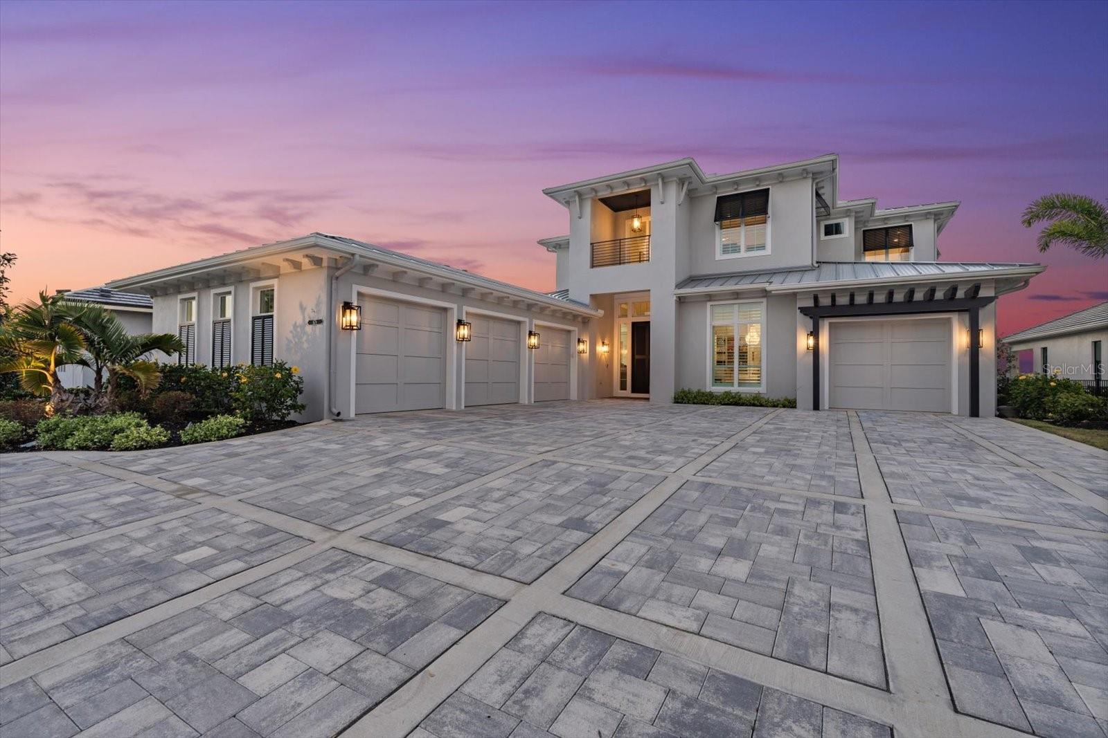 Welcome to 676 Regatta Way — a custom 2021 luxury waterfront home in The Reserve at Harbour Walk at The Inlets. This exceptional estate is designed for both privacy and entertaining, offering breathtaking year-round sunset views, direct boating access, and indoor-outdoor living at its best.
Features include a zero-edge infinity pool with gas fire pit, outdoor kitchen, expansive balcony, oversized driveway apron, and generator. Inside, enjoy an open floor plan with soaring ceilings, custom window features, chef’s kitchen with luxe appliances, butler’s pantry, icemaker, insta-hot filtered water, and custom cabinetry throughout.
The private master wing boasts a spa-inspired bath with oversized soaking tub, steam room, and private outdoor shower. Four additional en suite bedrooms include a balcony suite overlooking the Manatee River. The four-stall garage with built-in storage offers flexibility for oversized vehicles, toys, or workshop space.
Enjoy quick boating access to Anna Maria Island, the Gulf, Sarasota, and more. Close to Lakewood Ranch, Sarasota Polo Club, shopping, nightlife, and major airports.
Showings by private appointment only. Proof of funds required prior to scheduling.