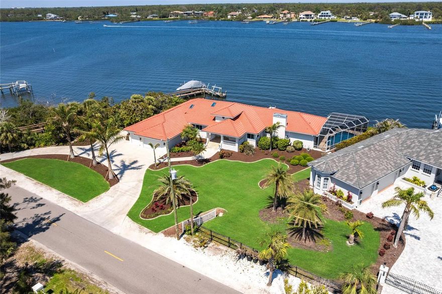 Welcome to 8115 Manasota Key Road—an extraordinary waterfront estate where refined luxury and coastal living converge. Perfectly situated on Lemon Bay with the beach directly across the street, this one-of-a-kind property offers an unmatched lifestyle—sunrise mornings on the bay, sunset walks on the beach, and effortless access to boating, dining, and everything this exclusive island has to offer. From the moment you enter, you're greeted by a grand foyer that sets the tone for the rest of the home. Soaring ceilings and a stunning wood-burning fireplace anchor the expansive living space, creating a warm yet elegant atmosphere. The open-concept layout flows seamlessly into the heart of the home—a spacious, thoughtfully designed kitchen with ample counter space, beautiful cabinetry, and a layout that invites both daily living and upscale entertaining. Nearly every room captures a breathtaking view of the water, bathing the interiors in natural light and offering a constant reminder of the peaceful waterfront setting. With 5 bedrooms—including two luxurious en-suites—2 guest bedrooms, a spacious office plus a formal dining room and a charming breakfast nook, there’s plenty of space to host friends and family. The indoor-outdoor connection is truly exceptional. Step outside to a newly resurfaced, pool surrounded by a private screened-in lanai, where you can relax, entertain, and take in the panoramic water views of Lemon Bay. Whether you're watching dolphins play, casting a line from your dock, or just enjoying the poolside, every moment feels like vacation. The home also features a 156-foot concrete seawall with private dock, providing direct boating access to the Intracoastal and quick trips to Stump Pass and the Gulf of America. Additional upgrades include new wide-plank floors, hurricane-rated windows and doors, fresh interior and exterior paint, a 2022 concrete tile roof, and professional landscaping by Hazeltine. The oversized three-car garage and spacious circular driveway complete this exceptional house. Whether you’re looking for a luxurious retreat or a show-stopping entertaining home, 8115 Manasota Key Road delivers on every level. Schedule your private showing today and experience the coastal lifestyle at its finest.