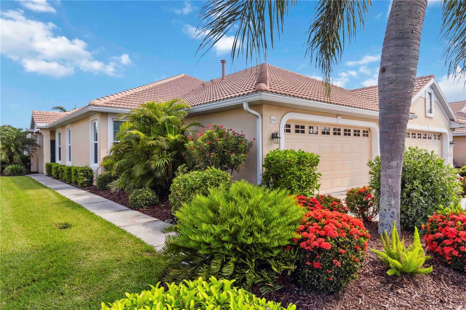 Enjoy the Florida lifestyle in this exquisite 2 bedroom 2 bath + den/study villa with a heated pool! This impeccably kept villa is located in the exclusive gated golf course community of Heron Creek Golf and Country Club. This home offers one of the largest customized floor plans in the Osprey Cove neighborhood and is situated with views to the green of the 5th hole of the Oaks golf course. Prepare to be captivated by the numerous upgrades and luxurious features that make this home truly exceptional. Once inside you will notice the elegant crown molding that adorns every room adding a touch of sophistication to the charming ambiance. You will delight with the abundance of windows, highlighted by plantation shutters, allowing for lots of natural light to flow through. The dining area is accented with a decorative column creating a wonderful space to enjoy delicious meals with your family and friends. The kitchen is a chef’s delight with Stainless Steel appliances, gas cooking, solid maple wood cabinetry with pull out shelves, under cabinet lighting, corian countertops, tiled backsplash, breakfast bar with pendant lighting, and closet pantry. There is lots of room in the generous size great room with triple sliders leading to the sparkling heated pool and lanai area with views of the golf course, making for a nice gathering spot for you and your guests. The primary bedroom is complimented with a tray ceiling, windows overlooking the golf course, walk in closet and en-suite bath. The ensuite bath is truly a retreat boasting a spacious walk in shower, soaking tub, and dual sinks. The split floor plan design provides privacy for your guests where they will enjoy a spacious guest bedroom, and adjacent bath with a tub/shower combination. Your oasis can be found in the den/ study for a welcomed getaway. Take in the beauty of the outdoors on the lanai and pool area while watching the golfers, nature and sunsets…the perfect place to end your day. Lots of extra touches in this magnificent home including, New Roof and Gutters(2024), Interior Paint (2024), New Washer and Dryer (2024), New Lanai Screens (2023), New Lanai Ceiling Fan (2023) New Hurricane Windows (20-22), New Pool Equipment including heater (2019), Epoxy Coated Garage Floor and more! This home combines sophistication and comfort for a delightful living experience. Immerse yourself in the Heron Creek Golf and Country Club Community and enjoy the first class amenities. For example, play the 27 holes Arthur Hills designed golf course with major practice facility, join in a tennis game on the 5 Har Tru lighted tennis courts, take a dip in the resort style pool and spa, workout in the newly updated fitness center, enjoy a bite at the newly renovated Courtside Cafe or experience casual and fine dining choices at the 21,000 sq ft Clubhouse. Heron Creek is vibrant community with a very active social calendar. One could say there is something for everyone. Heron Creek is close to beaches, shopping, restaurants, Warm Mineral Springs,and Cool Today Park. This is your opportunity to enjoy the wonderful Florida lifestyle today!