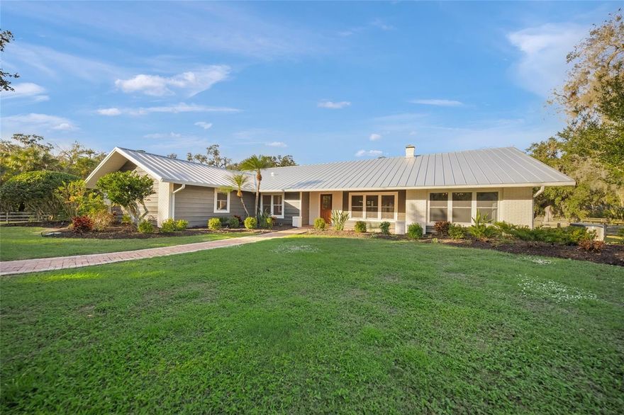 This is the one * THIS LOVINGLY RENOVATED & THOUGHTFULLY REIMAGINED HOME IS A TRUE SANCTUARY OFFERING A MAIN RESIDENCE & A GUEST HOUSE PERFECT FOR MULTI-GENERATIONAL LIVING * MAIN HOUSE is 2921+/- sqft a/c & GUEST HOUSE is 448+/- sqft a/c for a TOTAL LIVING AREA SQFT OF 3369+/- *

'A' RATED SCHOOL DISTRICT * A MUST SEE FAMILY ESTATE HOME IN MUCH SOUGHT AFTER SADDLE CREEK * PERFECTLY POSITIONED on 5.9 ACRES of PEACEFUL, PRIVATE LIVING in this GATED, EQUESTRIAN NEIGHBORHOOD with 25 MILES OF RIDING TRAILS * You will be truly impressed from the moment you enter the electric gate and drive down the ASPHALT & CONCRETE DRIVEWAY surrounded by LUSH GREEN PASTURES & MATURE OAK TREES * You will appreciate the IMPECCABLE GROUNDS, SERENITY & PRIVACY * TUCKED ON THE QUIET BACKSIDE OF SADDLE CREEK * The Chef's Kitchen opens to the Living Room and Family Room, both with Vaulted Ceilings and both featuring a Wood-burning Fireplace * There are Volume Ceilings providing an ABUNDANCE OF NATURAL LIGHT * Split Plan Design with a 25x15 Primary Suite showcasing a Spa-style Bath * French doors open to the OUTSIDE OASIS with a spacious Covered Lanai and a Caged, Heated Pool for year-round enjoyment of Florida's outdoor living * ADDITIONAL FEATURES INCLUDE: a Metal Roof, IMPACT GLASS WINDOWS, A WHOLE HOUSE GENERATOR, and a Reverse Osmosis Water System, all adding to your peace of mind * This is the perfect home for entertaining friends & family or for just relaxing in your slice of paradise * EQUESTRIANS will be delighted by the BEAUTIFULLY EQUIPPED BARN featuring 3 Stalls and a Tack Room, and Wash Rack * The property is CROSS FENCED with MULTIPLE PASTURES & a TRANQUIL POND * Bring the horses, the family, all the animals, the big & small toys * Make this your family estate * ENJOY YOUR SLICE OF PARADISE * Beautiful private setting * SADDLE CREEK has over 25 miles of riding trails * EXCELLENT A-RATED SCHOOLS * 5 miles to I-75 & 13 miles to Siesta Key Beach * 5 minutes to Publix & shopping * Country feel yet close to town * One look & you'll fall in love *