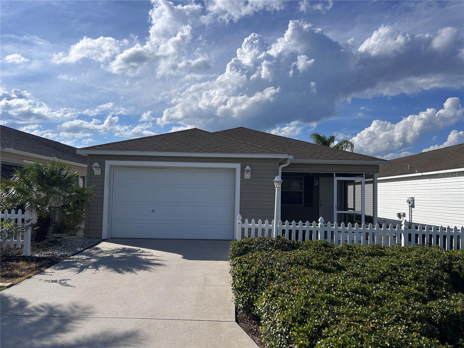 Discover your future home in the heart of The Villages, perfectly nestled in the sought-after St Charles Place Community. Enjoy unrivaled convenience with quick access to Lake Sumter Landing, Brownwood Square, Hwy 466 and Hwy 466A. This location offers a short golf cart ride to the Seabreeze Recreational Center/Pool, Championship Golf and Executive Golf Courses. This Villa offers a Spacious interior with Ceramic Tile Flooring in all Main Living Areas.White Kitchen/Bath Cabinets and Stainless Steel Appliances. Enjoy the Brand New Carpet in the Cozy Bedroom Areas. The expansive primary bedroom comes complete with an en suite and generous walk-in closet, providing ample storage for all your wardrobe needs. Benefit from the ease of an interior washer and dryer making laundry days a breeze and cool for those Summer Months. The Colony Villa offer a lovely Patio Area, ideal to enjoy soaking up the Beautiful Florida Weather or gathering with friends and family. This home is being offered with an EZ-GO Electric Golf Cart to make your Villages Lifestyle transition that much more convenient.