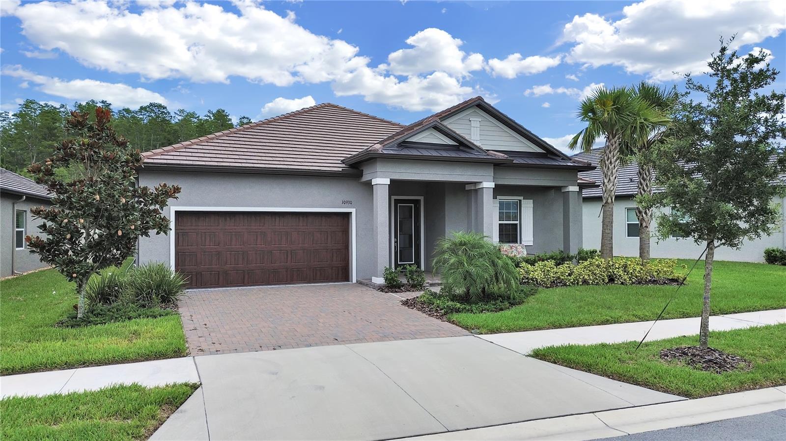 Welcome to Angeline, a new 6,200+ acre master-planned community in Land O' Lakes, offering an active lifestyle for 55+. This Beautiful Single Family (Argent Model) Home offers over 2200 heated sqft of living space located on a premium conservation lot, within walking distance to club house. Open Floor plan with high ceilings, crown molding, Premium Slate Tile Roof, Front Exterior Brick Pavers and Wood-Like Garage Doors. This home offers an Open floor plan with Kitchen, family room and Dining area with access and view of conservation area. The Kitchen has a large island breakfast bar with quartz counter tops with built-in appliances and walk-in pantry. The Laundry Room is off the Kitchen with storage cabinets. The Beautiful Master Suite with Tray ceiling and Ceiling fan with a view of conservation area. The large Master Bath has double vanities, shower stall with bench, oversized walk in closet. An additional bedroom with a private bathroom is perfect for guests. The Front flex-room can be used as an office space. Relax on the covered screen patio overlooking conservation view, with custom flooring and pull-down shades. The two-car garage has easy access to the extra storage space in the attic for storing your items.
At Angeline you will experience exceptional amenities. Enjoy access to a modern 55+ only clubhouse, resort-style pool, state-of-the-art fitness center, and courts for pickleball, billiards, shuffleboard and bocce, banquet rooms with large event hall and stage. The monthly calendar lists all the fun activities, live entertainment. Enjoy walking, biking or jogging the 100 miles of planned trails and paved pathways, community farm offering exceptional fresh produce, and 3,600 acres of green space. Angeline is also home to the future 775-acre Speros FL Moffitt Cancer Center campus, placing wellness and innovation right at its doorstep.
HOA Fees include lawn, tree and bushes maintenance, home exterior painting, irrigation, yearly mulch, 2 GB internet. CDD is included in the taxes.