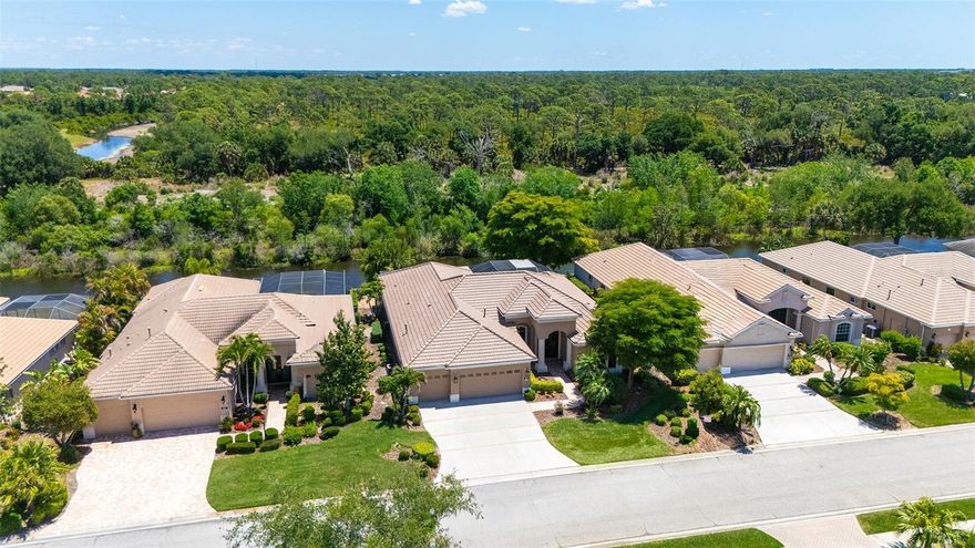 It’s always about the view and the new tile roof December 2025. This stunning waterfront home in Willowbend, bordering community greenbelt with views to Oscar Scherer State Park, is a luxurious Lee Wetherington-built Paloma floorplan designed to the highest standards, offering spectacular views and seamless indoor-outdoor living. On one of the community’s most desirable lots, it features unobstructed shimmering views of a wide lake and the natural beauty of the park, creating an extraordinary backdrop for an exceptional lifestyle. The idyllic setting includes a sparkling heated pool and spa. Summer kitchen has sink and stainless beverage refrigerator with large bar entertaining area. The exterior boasts a three-car garage and a double-door that welcomes you into an inviting, spacious interior. The home’s open floor plan includes living/dining with views to the natural beauty, tile on diagonal, crown molding and vaulted ceilings. Handsome office/den to the front of residence. The gourmet kitchen is equipped with granite countertops, stainless steel appliances, including built-in gas range and custom hood. Large walk-in pantry with oversized adjacent laundry room that has an additional deep closet. Dinette area features an aquarium window to take in the natural beauty. Family room is spacious with a corner pocket door that opens wide to let in Florida’s finest weather. The primary suite offers bamboo wood floors, double-tray ceiling and sitting area with French doors. California-style walk-in closets and a luxurious bath with dual sinks, a tub, walk-in shower and separate toilet. Each guest bedroom is generous in size with full bath in between. Additionally, it is a bonus living space with wood floors overlooking the serene setting. Third bath serves as pool bath. On a practical note, new water heater in 2026 and pool pump in December 2025. An amazing lifestyle awaits, all overlooking serene waterfront views teeming with wildlife such as eagles, osprey, otters, turtles and deer. The home is ideally near downtown Venice, Sarasota, Siesta Key, Nokomis Beach and Legacy Trail, offering easy access to cultural attractions, shopping, dining and recreational activities. Short distance to nationally ranked Pine View School. The community’s low fees include internet, Direct TV streaming, yard maintenance, irrigation, pool and spa, gym and pickleball, making this a harmony of luxury, comfort and stunning beauty.