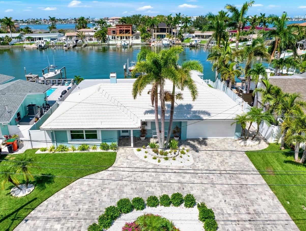 DON’T MISS THIS MAGNIFICENT 4BR/3.5BA WATERFRONT HOME IN THE COVETED OAKHURST SHORES NEIGHBORHOOD! Located in Unincorporated Pinellas County, this home sits on BEAUTIFUL water frontage and has been thoughtfully remodeled inside and out with nothing left to do but move in! THIS HOME IS A BOATER’S HAVEN, WITH 2 BOAT LIFTS (30,000lbs and 7,500lbs), a composite dock, and a location that’s just MINUTES TO THE GULF WITH NO FIXED BRIDGES! Inside, the spacious floorplan features all new luxury vinyl plank flooring throughout, a HUGE chef’s kitchen with new quartz counters and new appliances, including a gas range, built-in 2nd wall oven and microwave, built-in fridge, beverage cooler, dishwasher, and a huge island perfect for meal prep and dining! The living area boasts magnificent water views, a wood-burning fireplace, and crown molding. Enjoy 2 WALK-IN CLOSETS in the primary suite PLUS A STUDY with dazzling water views and an updated en-suite bath. Each of the 3 additional bedrooms have ample closet space, 2 have ensuite baths, and 1 has sliders that open to the pool area! Outside, in addition to the paver pool deck, there is a large covered composite deck. For safety, there is a picket fence along the seawall. The pool is saltwater with a spillover spa and brand new equipment as of 2025, including a natural gas heater (no propane tanks!). The entire home was re-piped with PEX in 2019 for $26,000 as well. THIS HOME IS FULL OF UPGRADES, including circular paver driveway (2019), Roll Shield hurricane shutters for all windows and sliders (2024), hurricane resistant exterior doors (2025), hurricane-rated garage door (2024), utility sink in garage, NEW FLAT ROOF (2024), new gutters (2024), seawall cap (2013), French drain system for pool deck (2024), 2 newer HVAC units (1 yr and 3 yrs old), tankless gas water heater, whole house carbon water filter, and so much more! Oakhurst Shores is a fabulous waterfront neighborhood close to top-rated schools, Seminole City Center, and biking distance to Madeira Beach! This is a neighborhood that had never flooded until Hurricane Helene in 2024. Don’t miss this home if you’re looking for a move-in ready slice of paradise by the beaches!