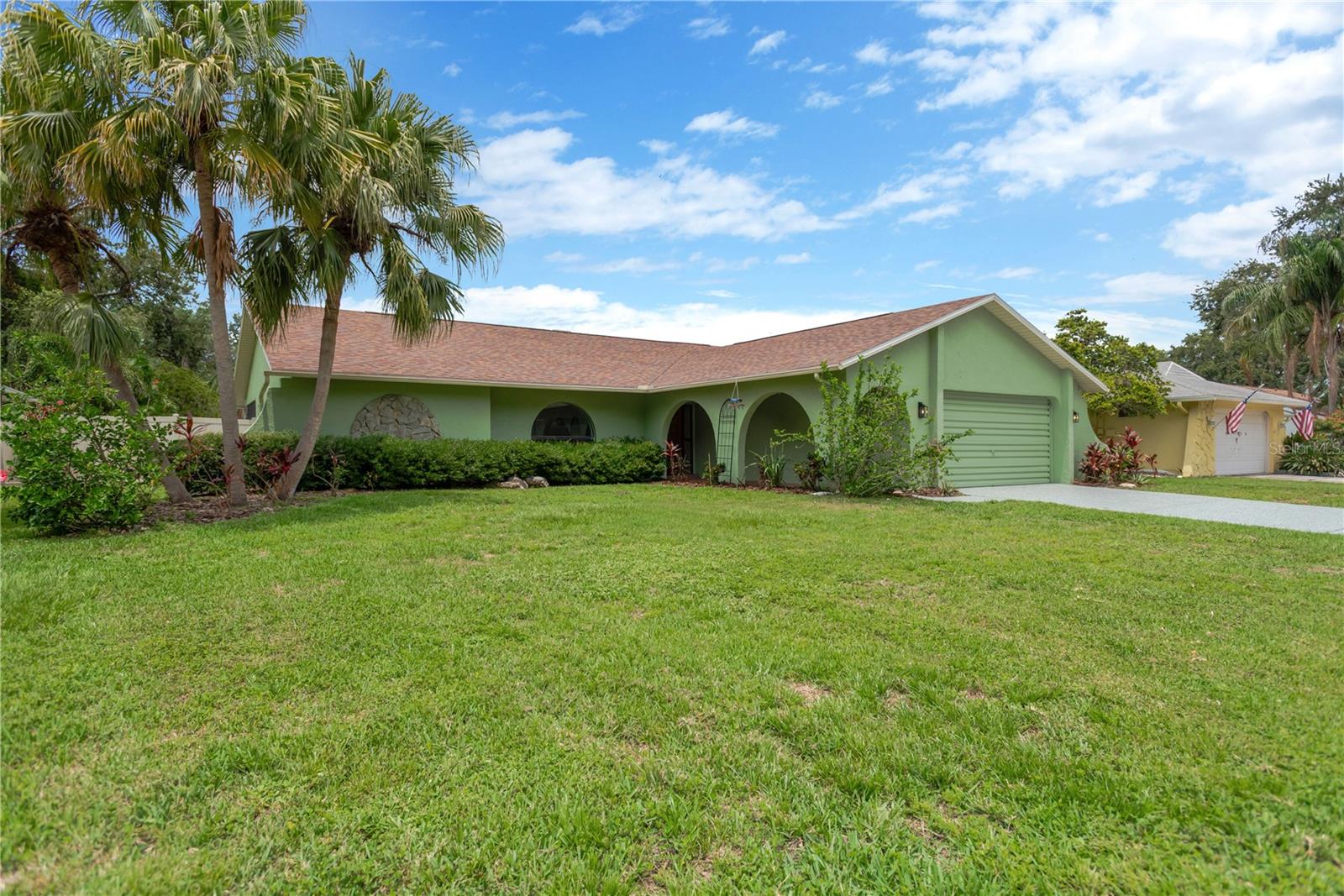 One or more photo(s) has been virtually staged. Welcome to this beautifully maintained 3-bedroom, 2-bath pool home in the highly desirable Bridgeport Estates of Safety Harbor! This move-in ready home features a split floor plan with both a formal living room and a cozy family room with a stone fireplace and views of the sparkling pool and huge backyard. Enjoy an eat-in kitchen, formal dining area, newer cabinetry. The oversized 2-car garage offers extra storage. Laundry room has a utility sink and closet. Step outside to a spacious screened lanai and an expansive vinyl-fenced backyard — perfect for little ones, pets, and entertaining. Recent upgrades include a new roof (2020) and hot water heater (2020), fresh interior paint (2025), NEST thermostat, and more. Ideally located just minutes from Philippe Park, downtown Safety Harbor, charming shops, restaurants, and year-round community events. Also just a short drive to Tampa International Airport, St. Pete, Honeymoon Island, and award-winning Clearwater Beach. No flood insurance required — enjoy peace of mind and the best of Florida living!