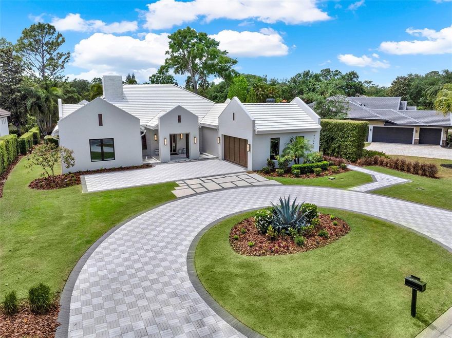 Located behind the private, 24-hour, guarded gates of the incredible Lake Nona Golf & Country Club, this custom-built residence blends modern design with transitional elegance in spectacular fashion. Redesigned by renowned architect Phil Kean in 2017, this 4,600+ SF masterpiece is situated on a quiet, double cul-de-sac street and offers a rare combination of privacy, beauty, and meticulous detail. From the moment you arrive, the oversized circular driveway, lush new landscaping and dual-entry courtyard fountains set a tone of refined sophistication. Inside, you’re welcomed by a grand foyer with coffered ceilings, elegant chandeliers, art alcoves, and stunning views stretching through the open-plan living space to the resort-style pool and serene pond beyond. The spacious living room centers around an extra-long gas fireplace with stone surround, surrounded by custom lighted art niches and unique coffered ceiling designs. The gourmet kitchen is truly a chef’s dream, featuring double islands, striking, custom, soft-close cabinetry, top-of-the-line appliances (including four ovens and a built-in espresso machine), a hidden walk-in pantry, and an impressive 185-bottle wine room. The primary suite offers a tranquil retreat with two custom walk-in closets and a spa-inspired bathroom with a wet room featuring a freestanding tub and large walk-in shower. Glass sliders provide direct access to the pool and backyard oasis. Two additional main-floor guest suites feature private baths, elegant finishes, and built-in closets. The dedicated home office, adjacent to the kitchen and garage entry, adds convenience and versatility. Upstairs, a private retreat awaits with a luxury wet bar, full bathroom, custom Frank Lloyd Wright-style Murphy bed and desk, and plenty of space for a 4th bedroom or loft—easily accessible by the residential elevator. Outside, your private paradise includes a square pool with sun shelf, gas firepit, summer kitchen, and motorized screened lanai—all designed for seamless indoor-outdoor living. A whole-house generator adds peace of mind. This is more than a home—it's a lifestyle defined by elegance, innovation, and comfort, nestled within one of Central Florida’s most exclusive communities.This exclusively private, 24 hour guard-gated, renowned Lake Nona Golf & Country Club home offers more than just a lovely home…it offers a “lifestyle;” one filled with family, friends, golf, lake living and privacy. All A-rated schools, within minutes of Orlando’s Intl Airport, Lake Nona’s Medical City, Boxi Park, USTA & situated between the 417 Greeneway & 528 Beachline. Don’t miss out on this unique opportunity!
