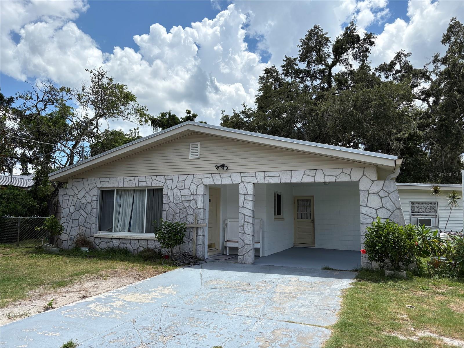 Great find in North Brandon! This 3/2 comes with 2 living areas, metal roof, large fenced yard, two storage sheds, huge utility/laundry room, bathrooms upgraded (2024), and hard surface floors throughout! The 50 year metal ROOF was installed in 2020, windows in 2020, electric panel upgraded in 2020, and disposal replaced in 2023. The back yard is a beautifully shaded sanctuary for puppies and people! Located close to shops, restaurants, and major roadways! Better come quick!