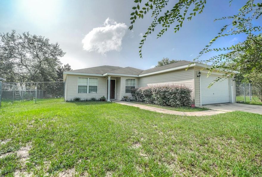 Extremely well maintained 3/2 home in Lady Lake that is located just a few minutes of all the dining and shopping in The Villages!! . This home is a two lot parcel, second lot is included in sale, over 1/4 acre. NO Hoa. Both lots are combined and are fenced. This home features tile floors throughout the entire home, a split open floor plan, and a screened back porch. Public water is currently connected. This is a magnificently valued home in the neighborhood and will not last long! Schedule your showing ASAP!!!